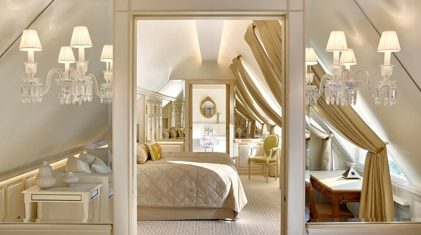 Elegant bedroom at Le Meurice, Dorchester Collection in Paris with crystal chandeliers