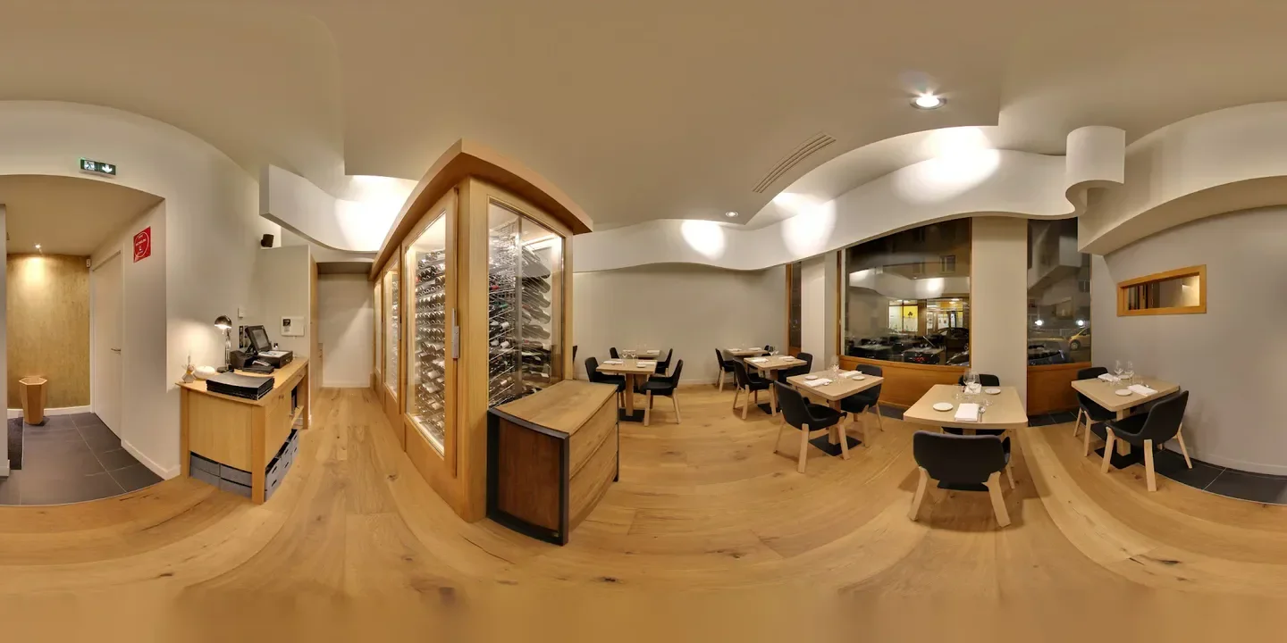 Interior of Le Passe Temps restaurant in Lyon, featuring elegant dining and wine display.