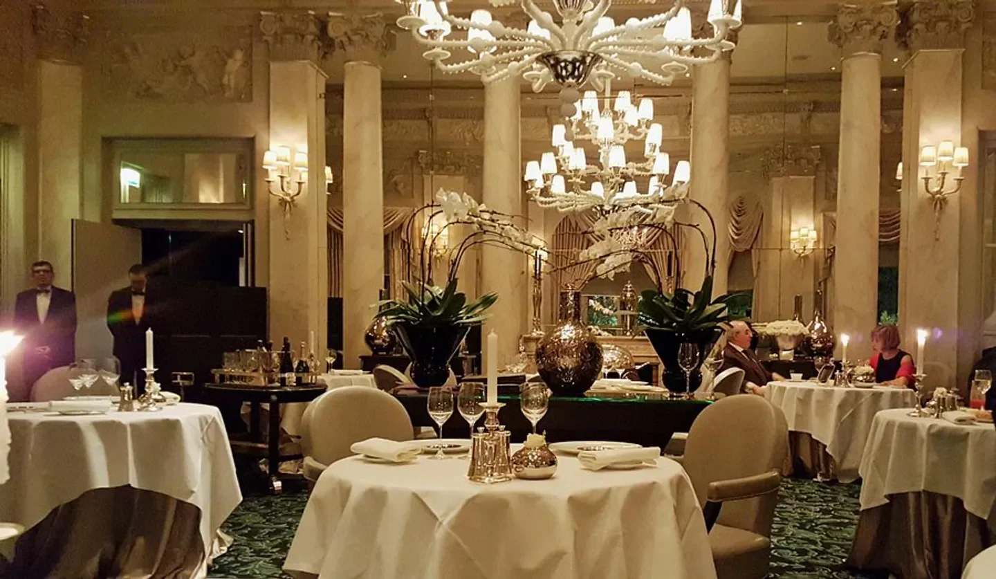 Elegant interior of Le Pré Catelan restaurant in Paris, featuring fine dining and chandeliers.
