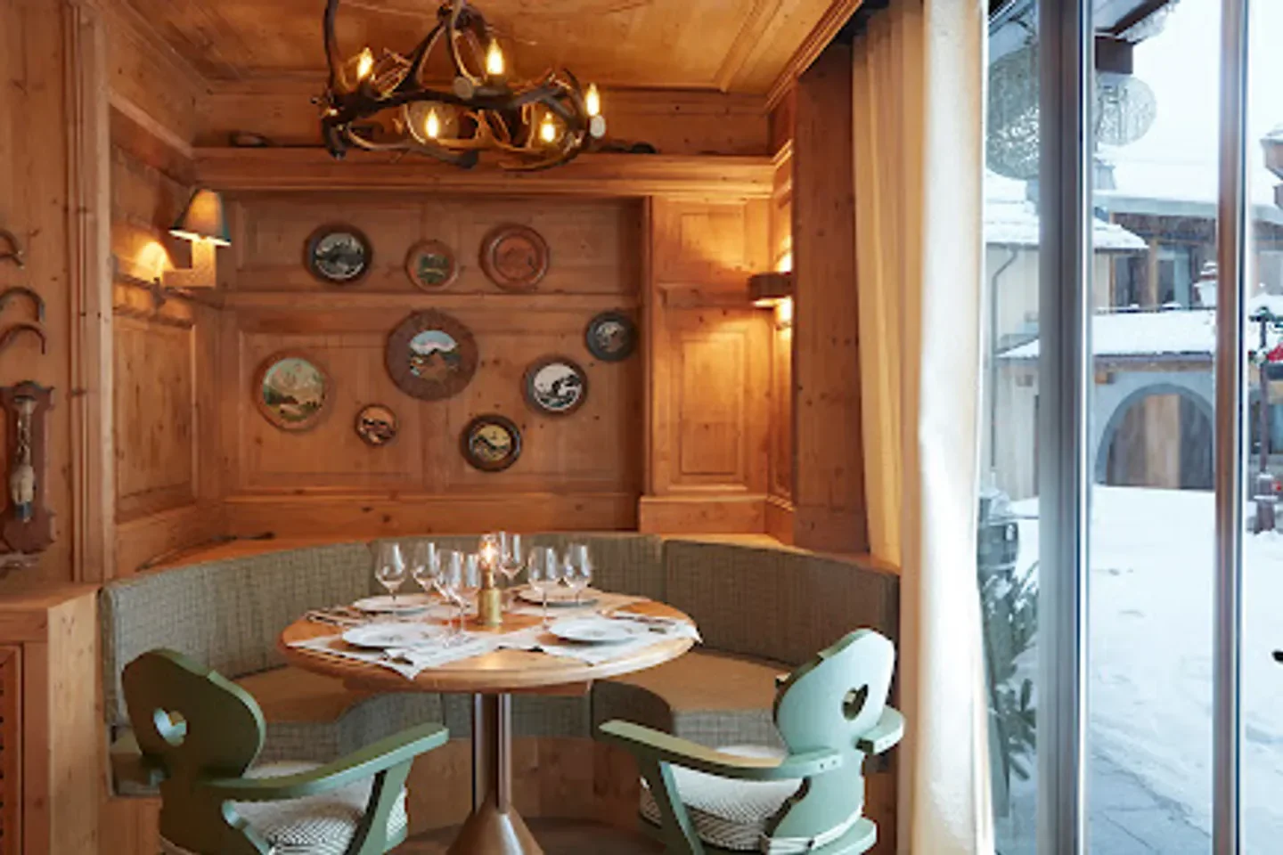 Cozy dining area at Le Relais restaurant in Megeve, featuring a wooden interior.