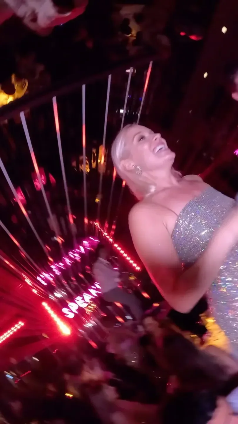 Glamorous party scene inside Le Speakeasy in Cannes, featuring bright lights and celebration.