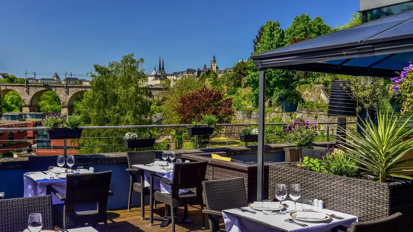 Outdoor terrace at Le Sud restaurant in Luxembourg with city views and bridge