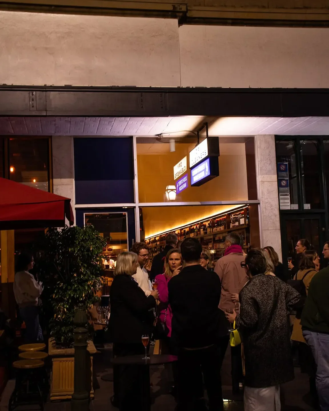 Evening scene outside Leigh Street Wine Room in Adelaide, with patrons enjoying drinks