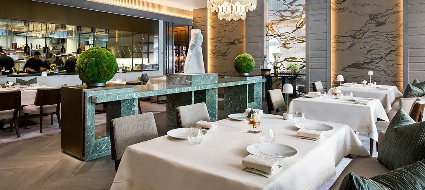 Elegant dining room interior at L'Envol restaurant in Hong Kong, with marble details.