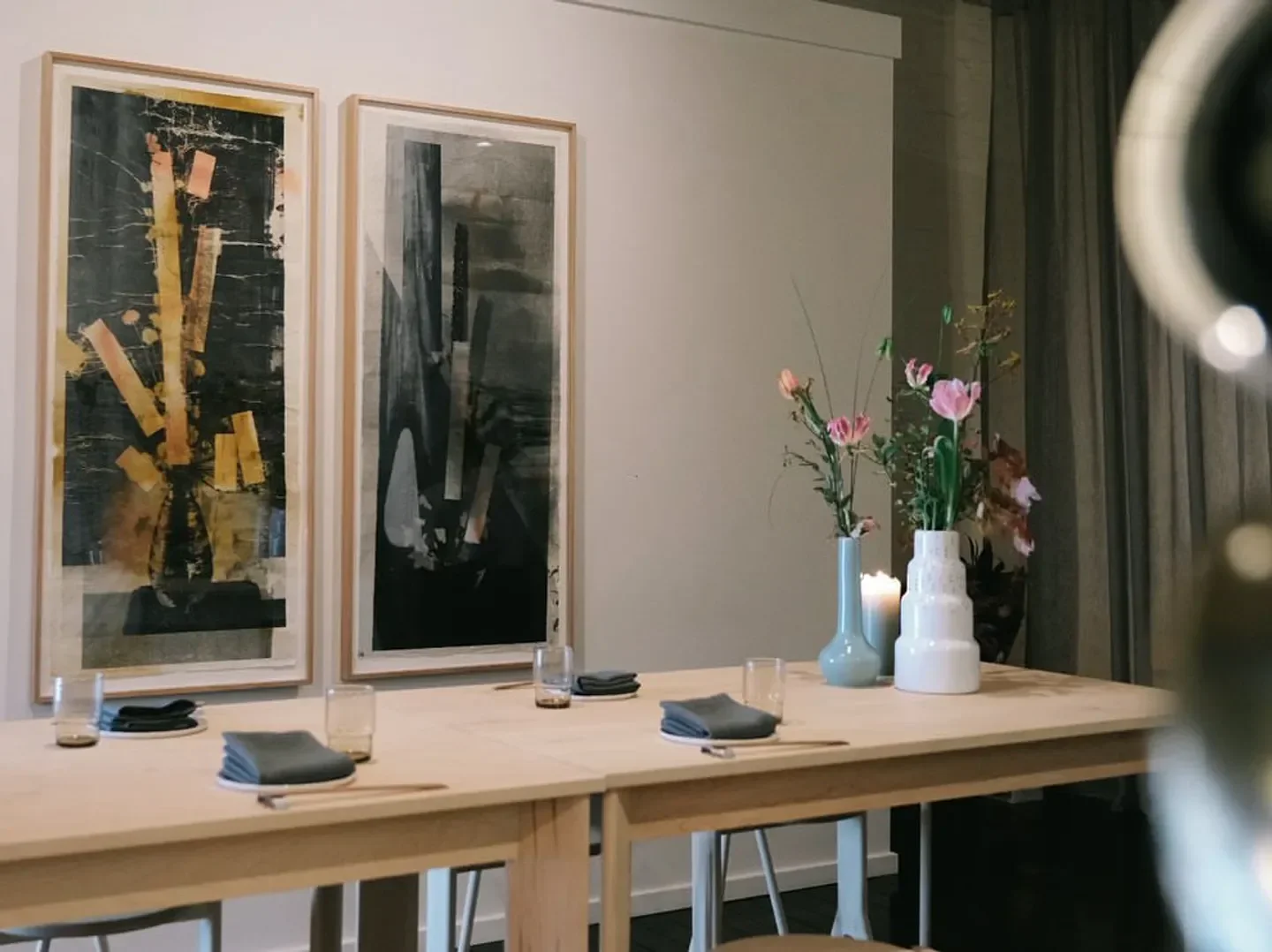 Interior dining at Leonie Upstairs restaurant in Melbourne, with table setting and art.