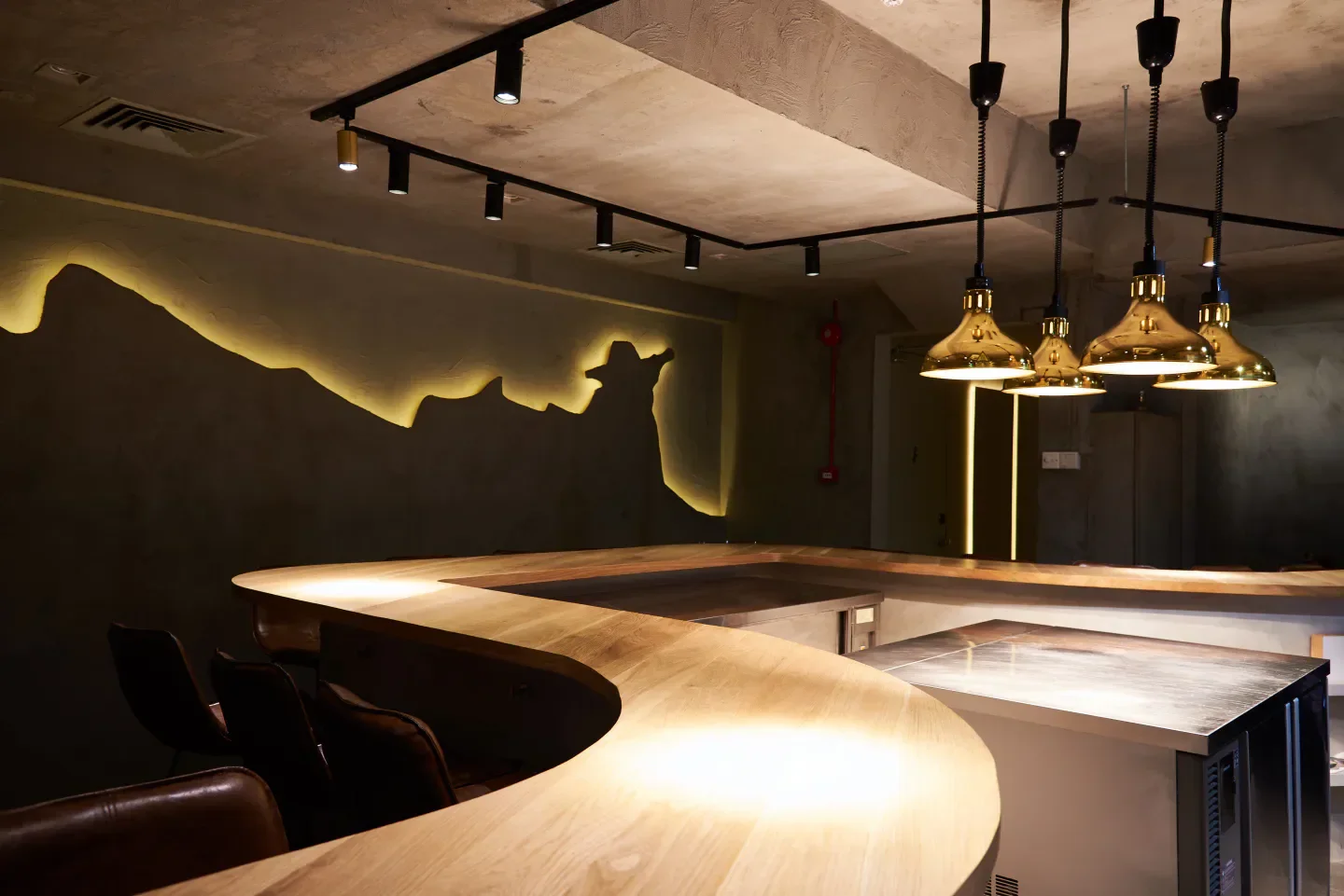 Elegant interior of Lerouy restaurant in Singapore, featuring unique lighting and bar design.