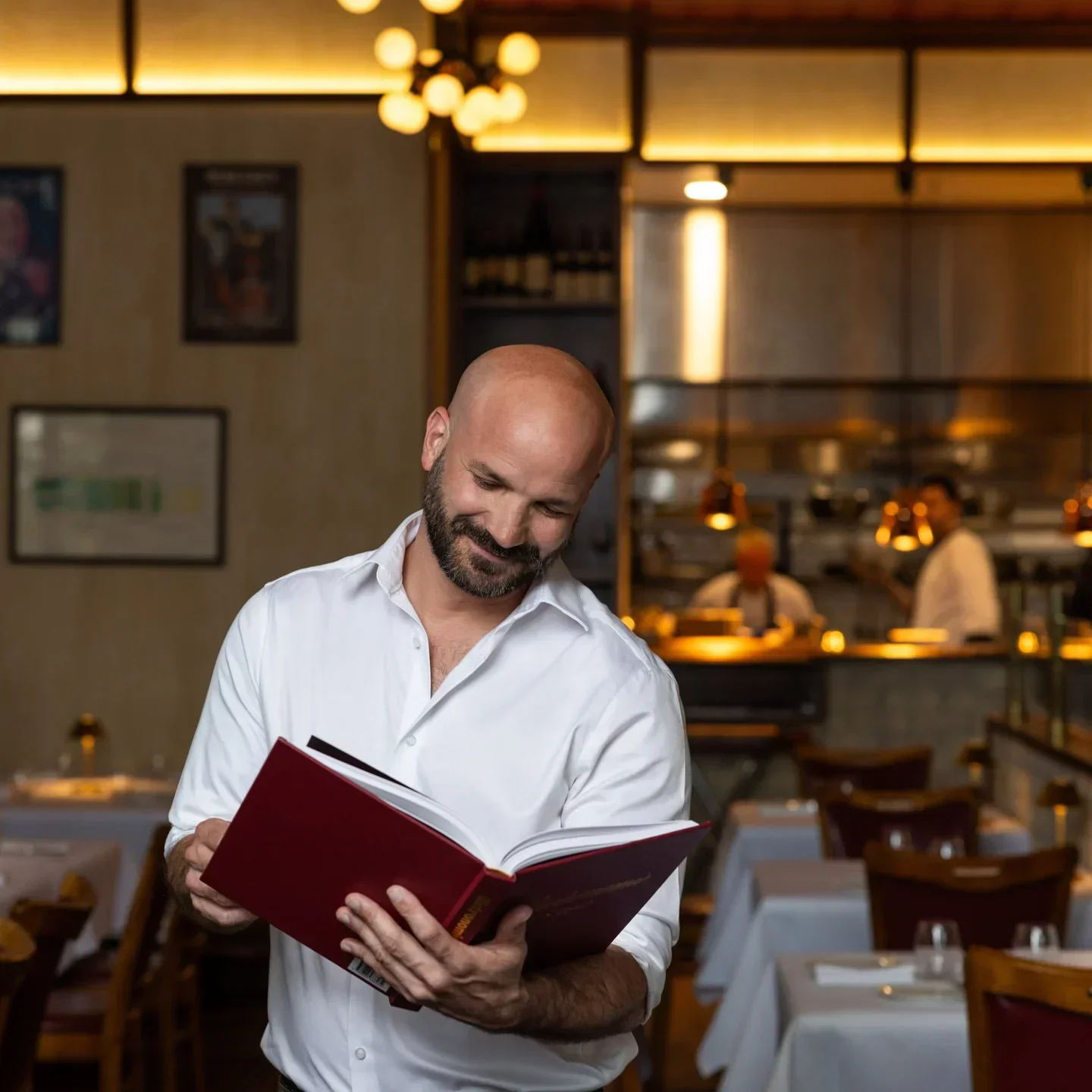 Les Bistronomes, a Canberra restaurant, with a man looking at a menu in the dining room