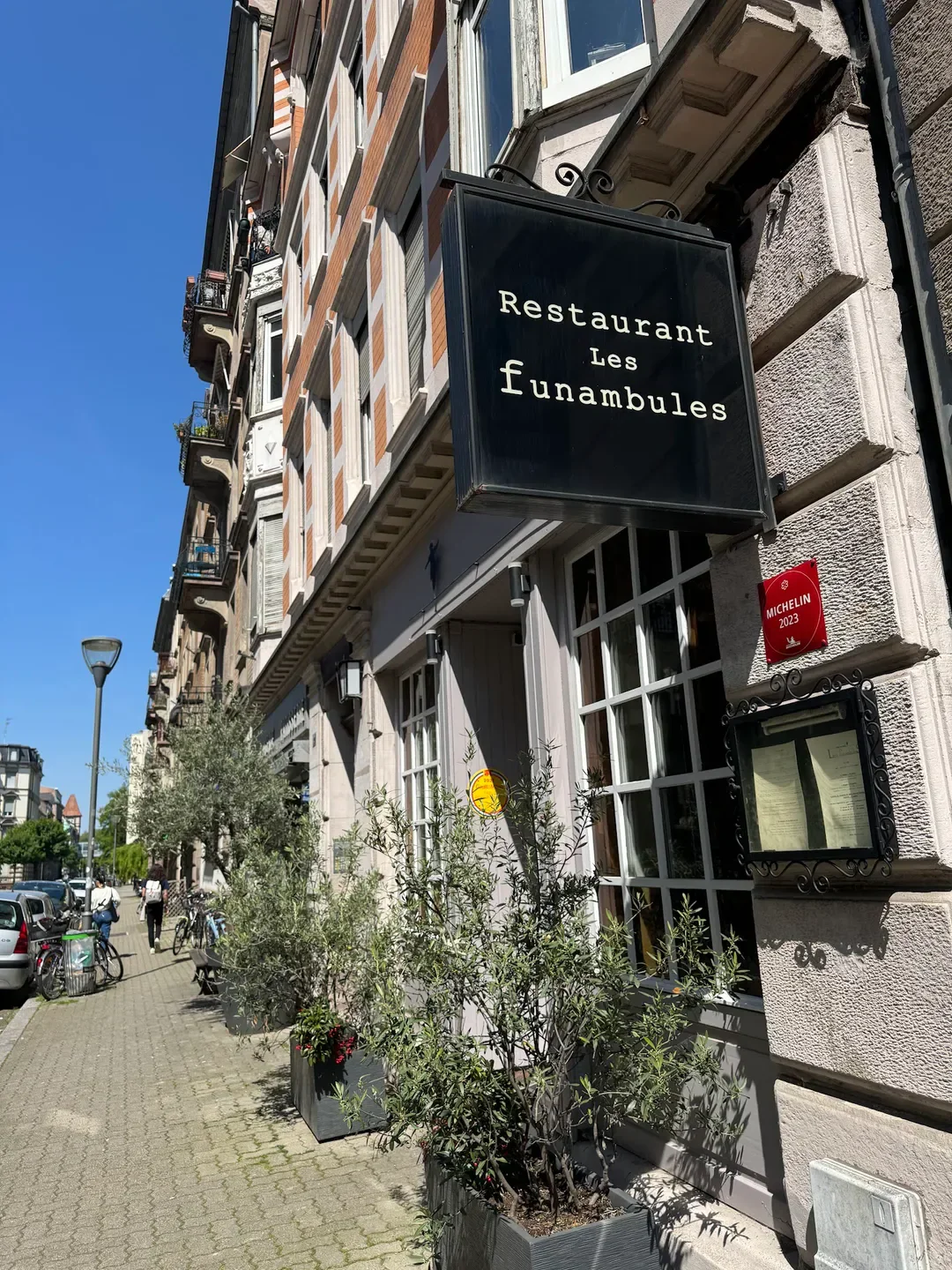 Restaurant Les Funambules in Strasbourg with Michelin Guide sign on the building.