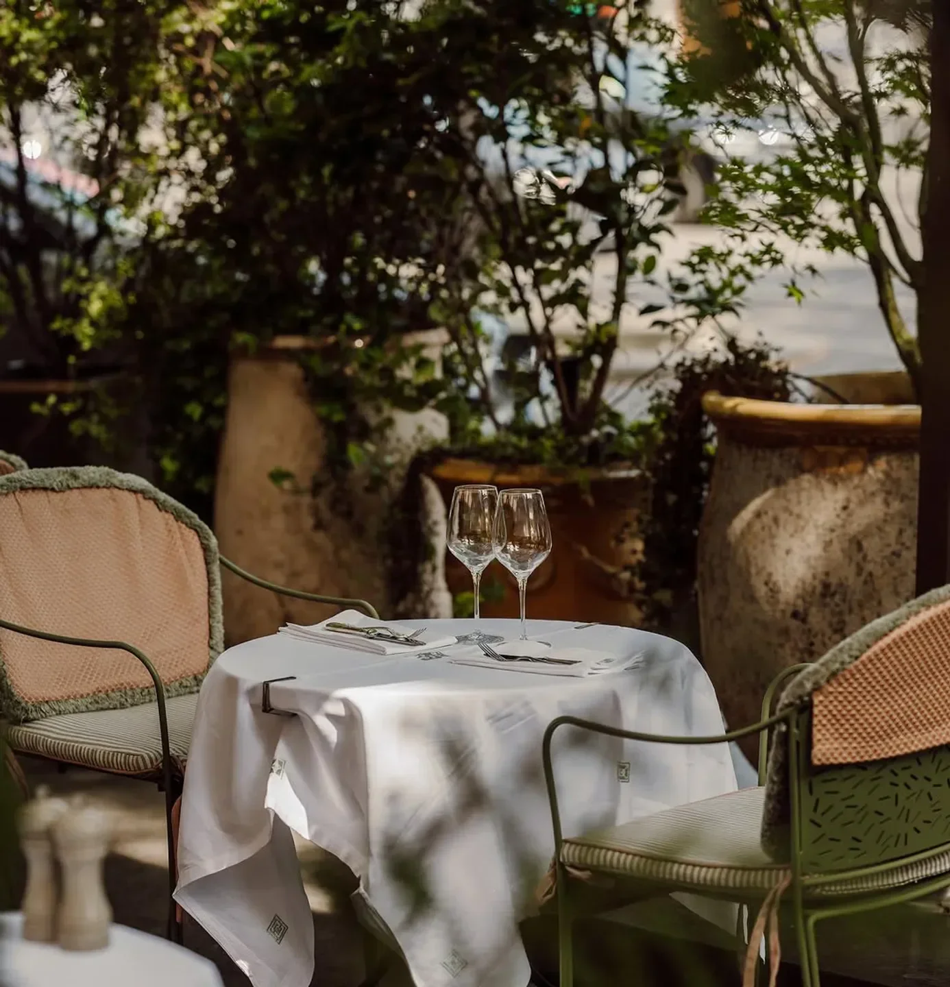 Outdoor seating at Les Jardins du Presbourg in Paris, ready for a delightful dining experience.