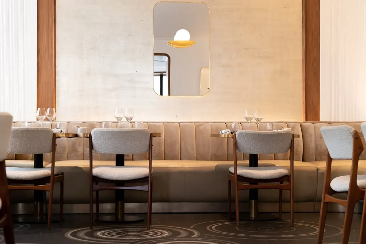 Interior of Les Parisiens restaurant in Paris, with stylish chairs and elegant decor.