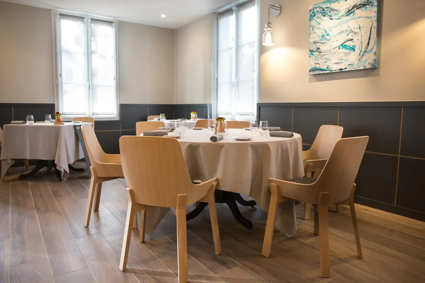 Interior of Les Rosiers restaurant in Biarritz, with elegant tables and chairs.