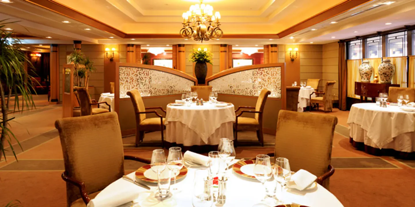 Elegant dining room interior at Les Saisons restaurant in Tokyo with table settings