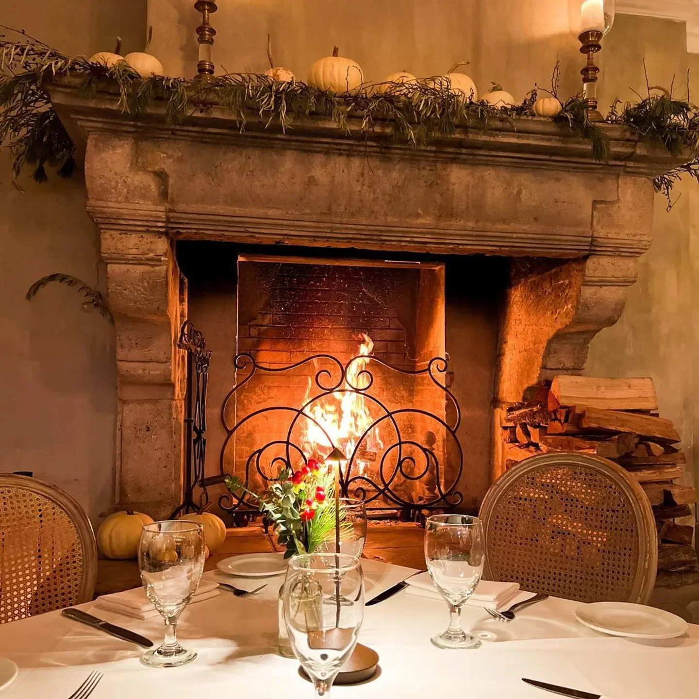 Cozy fireplace at L'Escale Restaurant in Greenwich, ready for a warm dining experience.