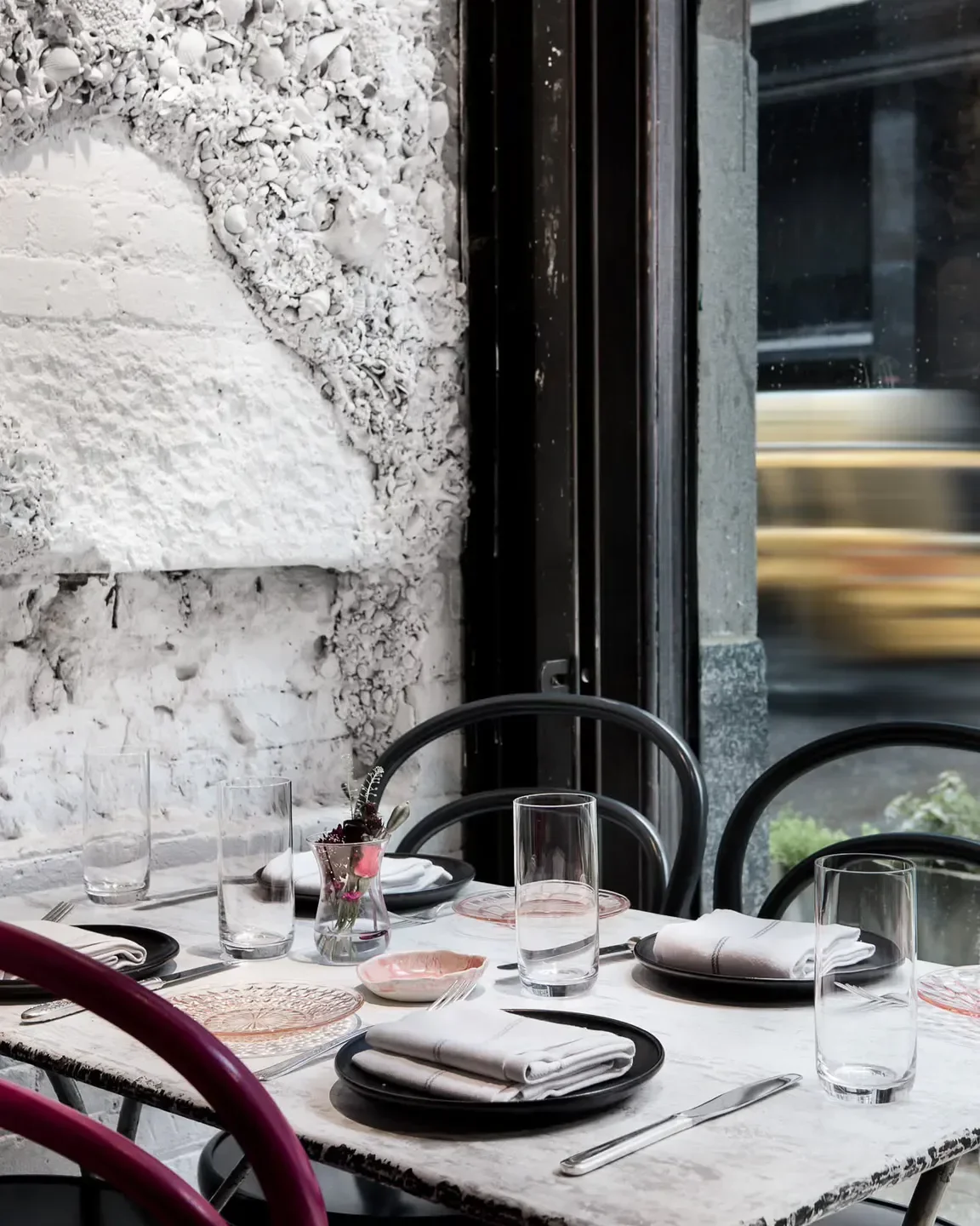 Elegant table setting at L`Europe Restaurant in St Petersburg, with artistic wall decor.