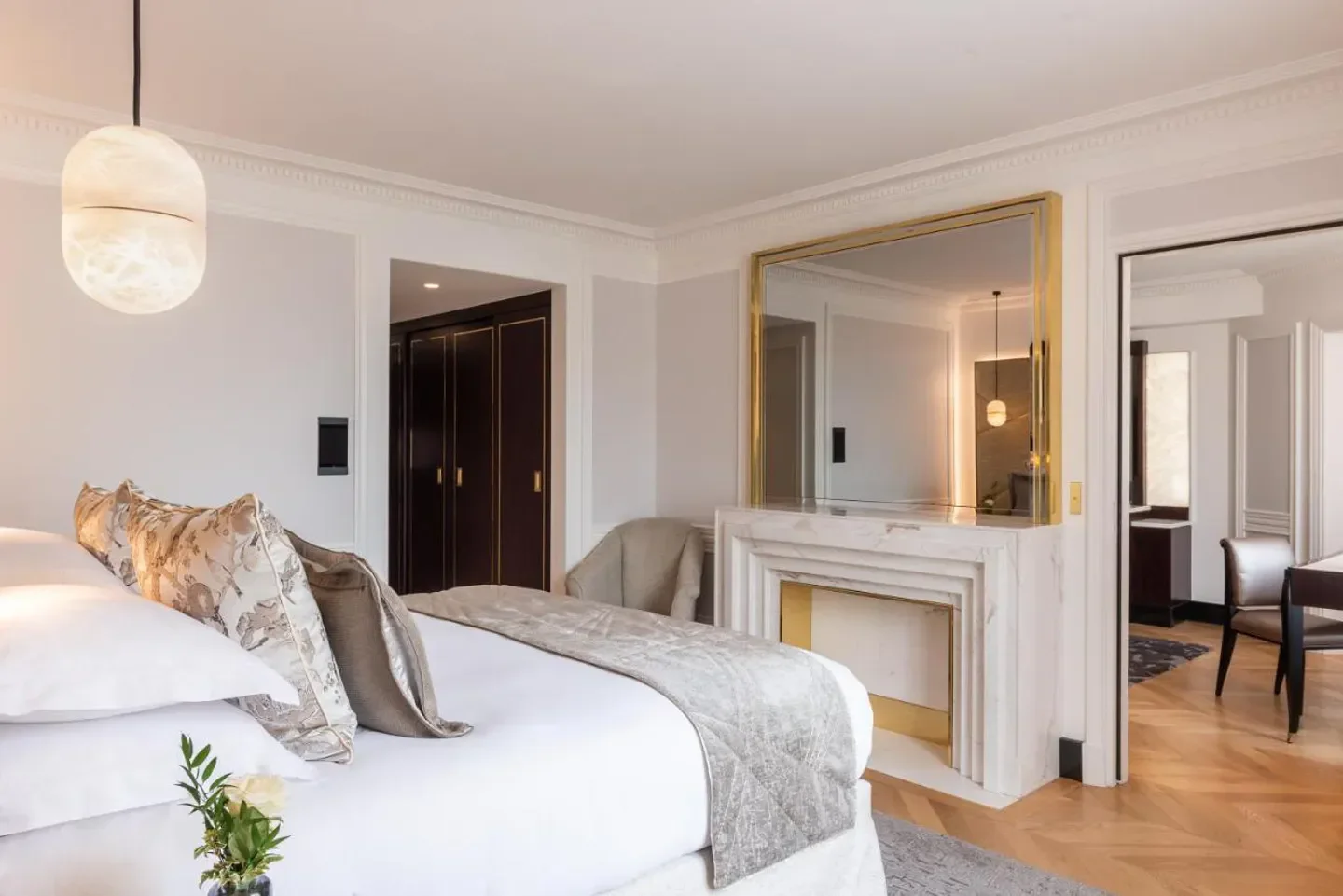 Elegant bedroom at L’Hotel du Collectionneur in Paris, featuring fireplace and stylish decor.