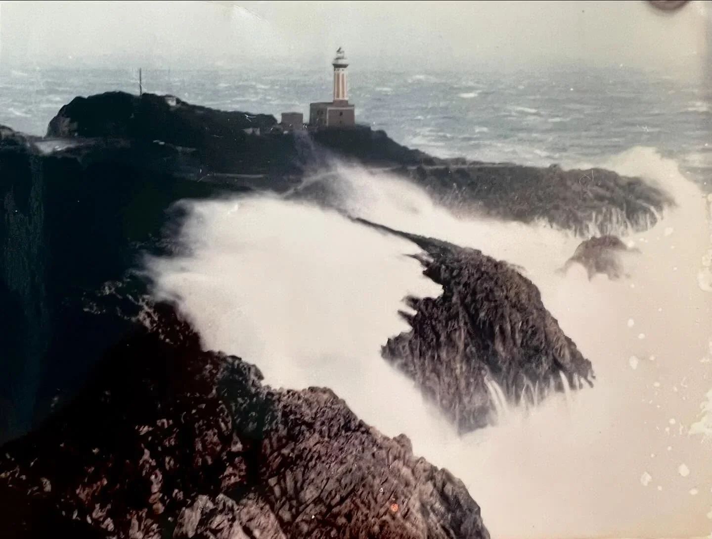 Lido del Faro restaurant in Capri offers stunning ocean views with waves crashing against rocky shores.