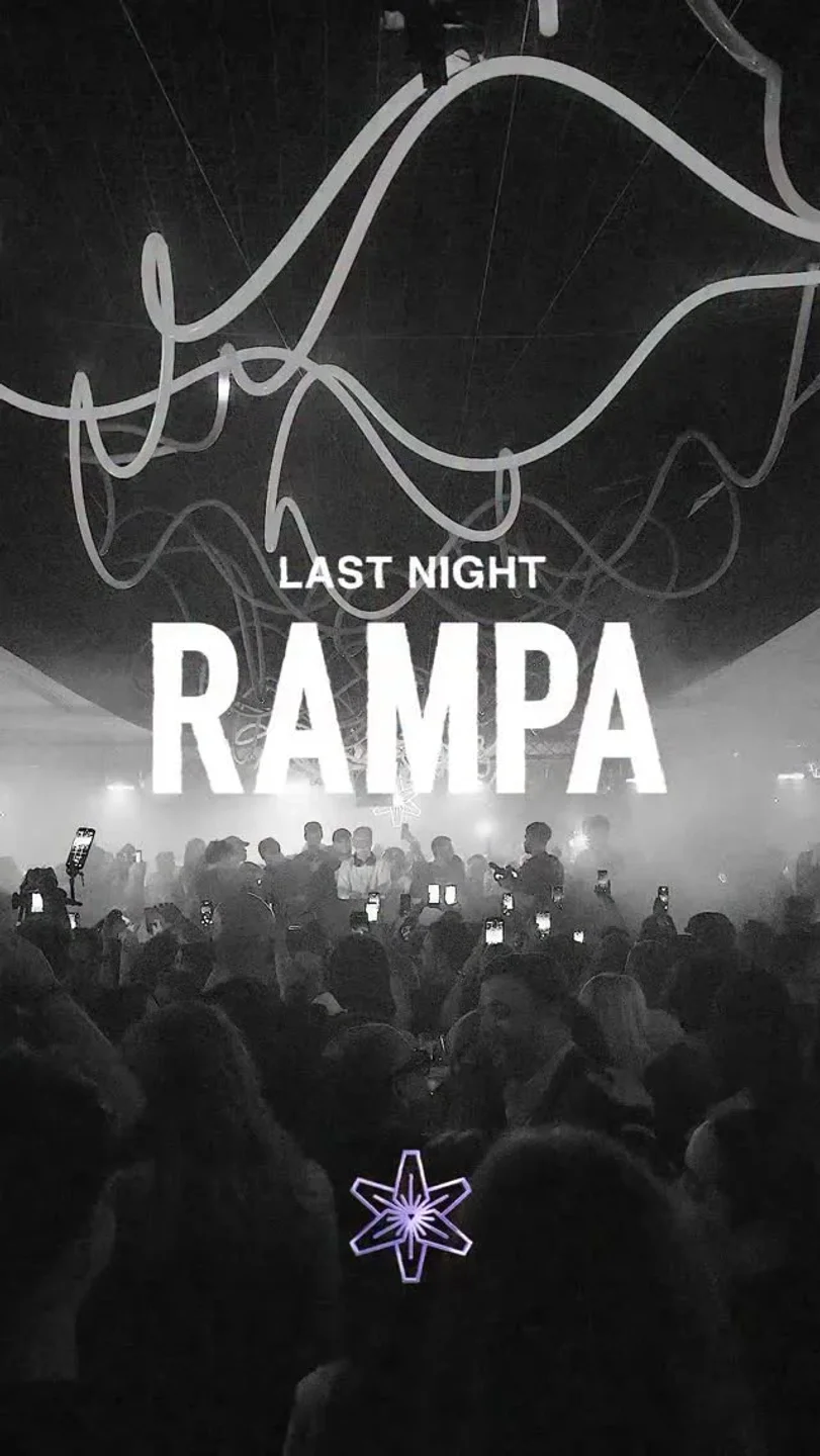 Crowd with hands up at Lilly's Club in the city, illuminated by dramatic lighting and "RAMPA" text.