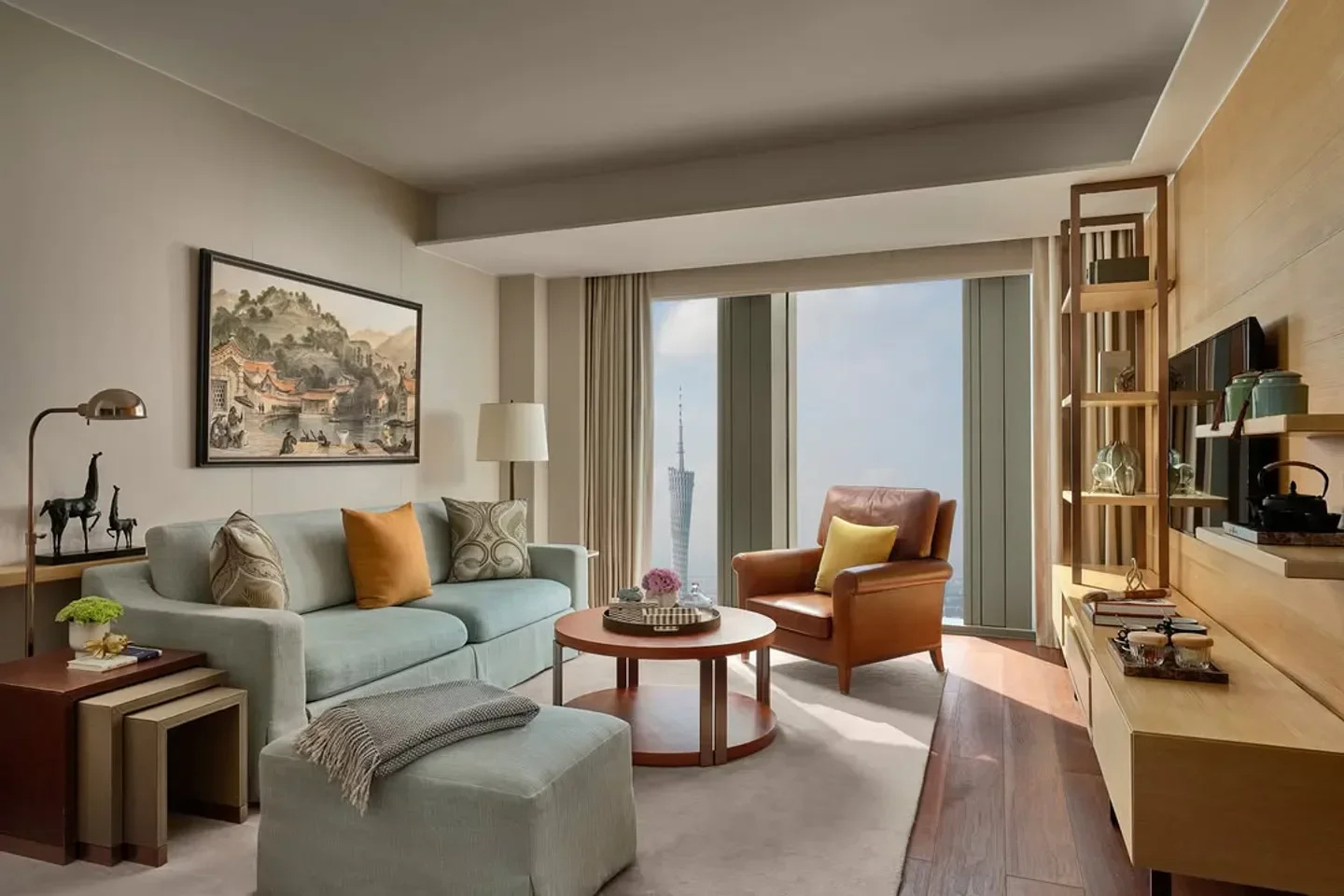 Cozy living room interior at Lingnan House in Guangzhou, with city views and artwork