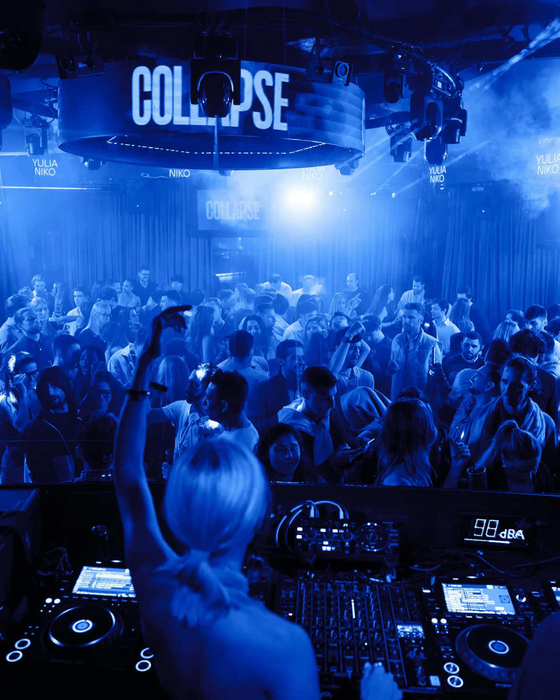 Crowded nightclub scene at Lío Mykonos with DJ booth and energetic atmosphere