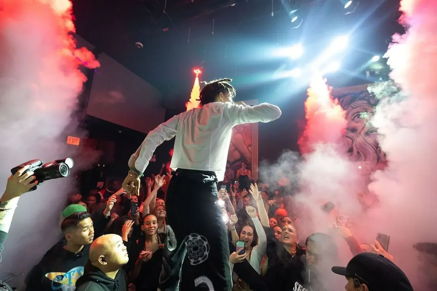 Energetic performer at Liqrbox Chicago nightclub with a crowd of cheering fans