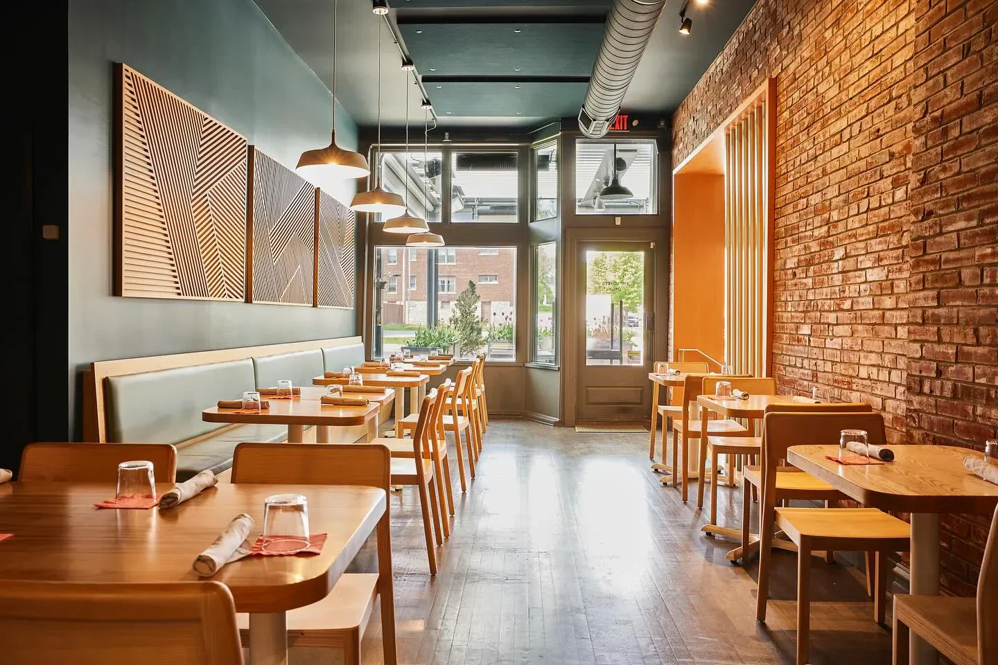 Interior of Little Fox restaurant in St. Louis, featuring brick and wooden decor.