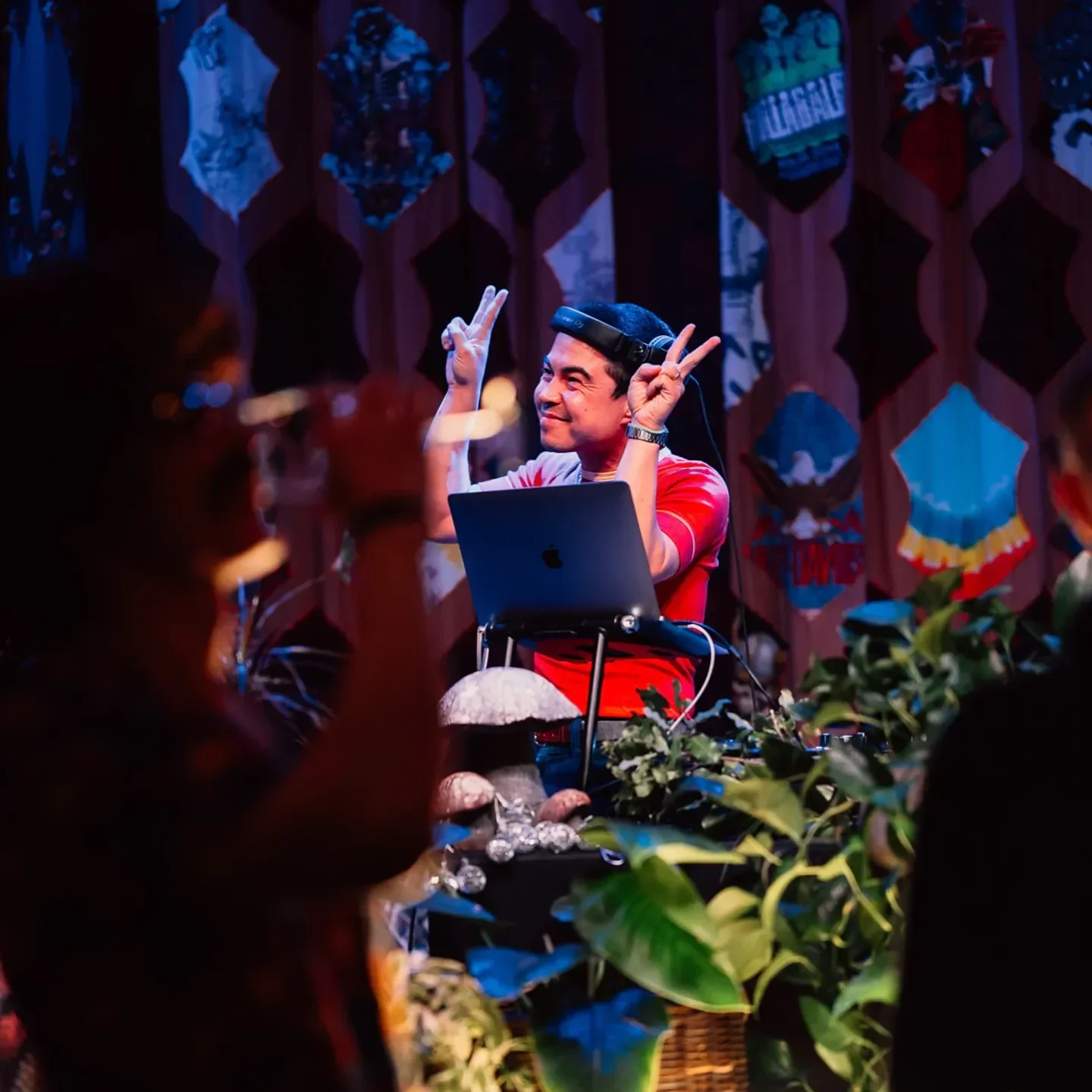 DJ at Little Saint in Healdsburg, performing with plants and colorful decor.