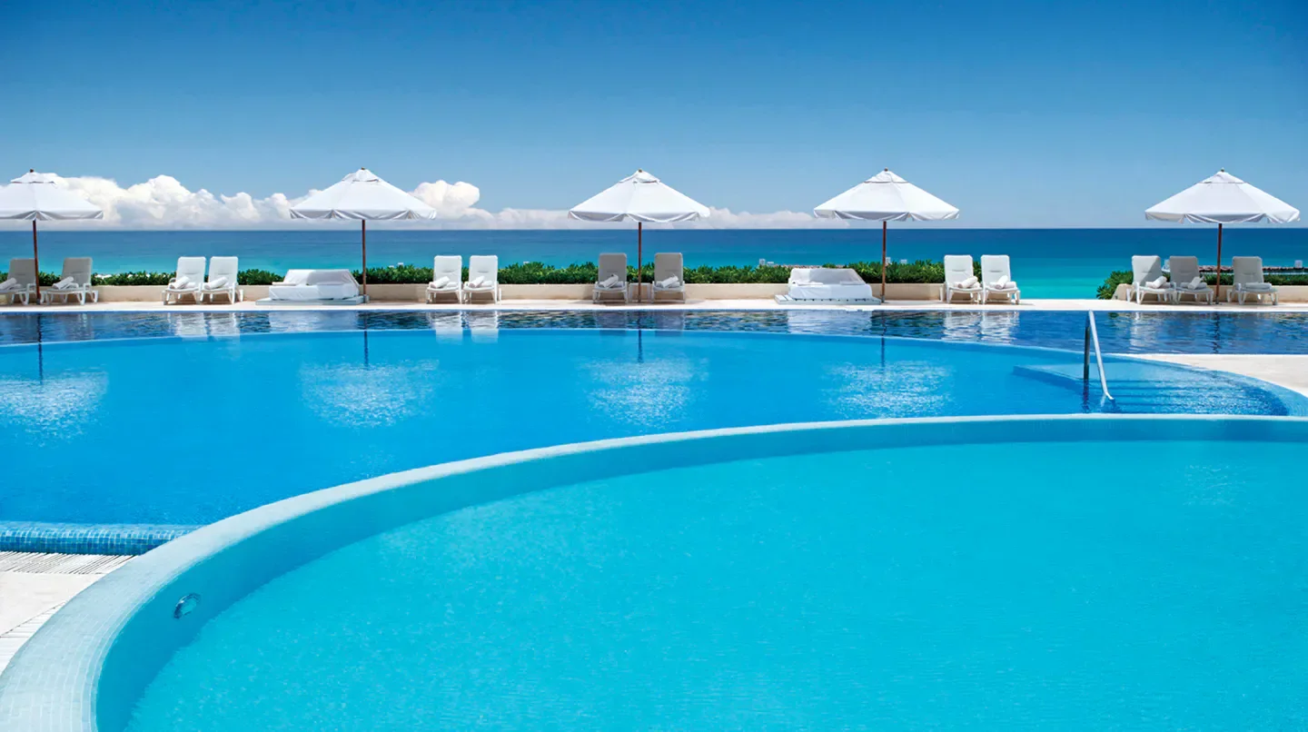 Pool and ocean view at Live Aqua Beach Resort Cancun, a luxury hotel in Cancun.