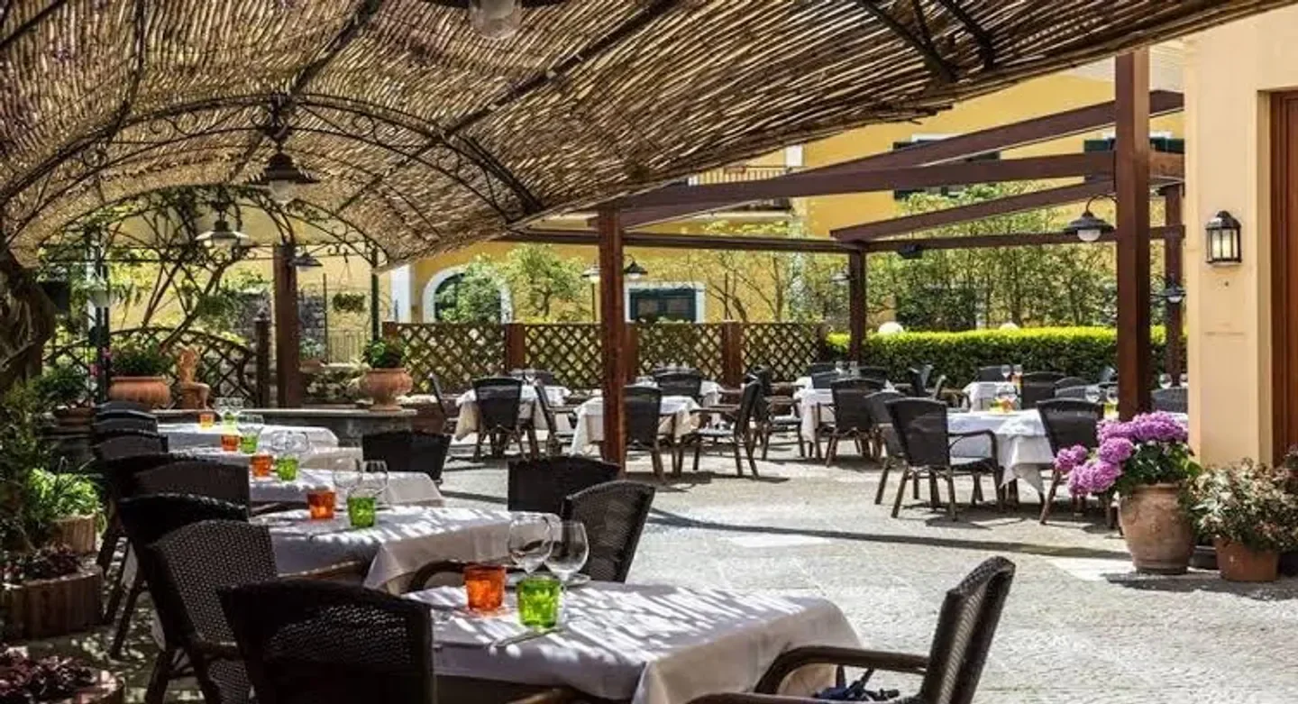 Outdoor dining at Lo Stuzzichino restaurant on the Amalfi Coast with tables set