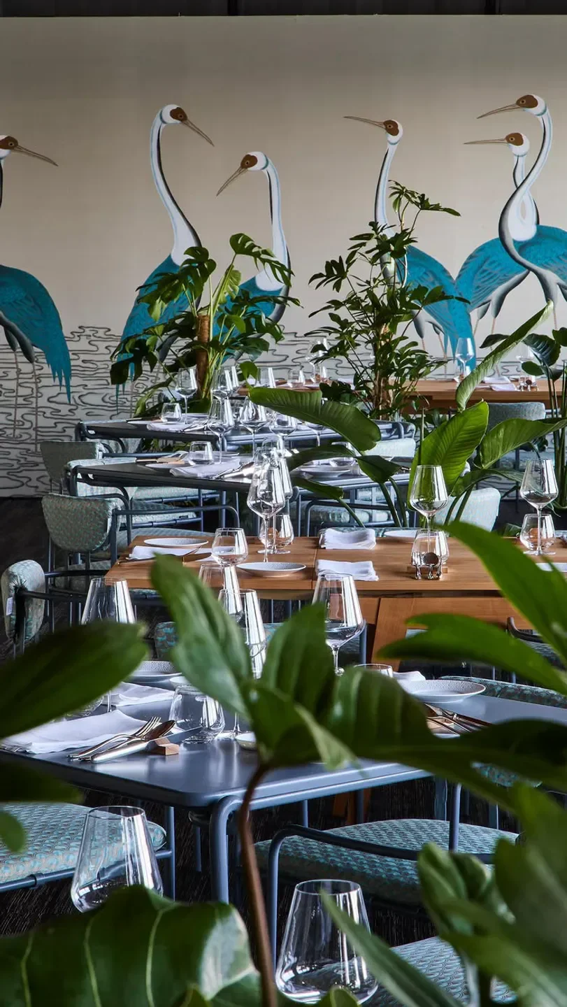 Restaurant in Venice. Local dining with artistic mural and elegant table setting.