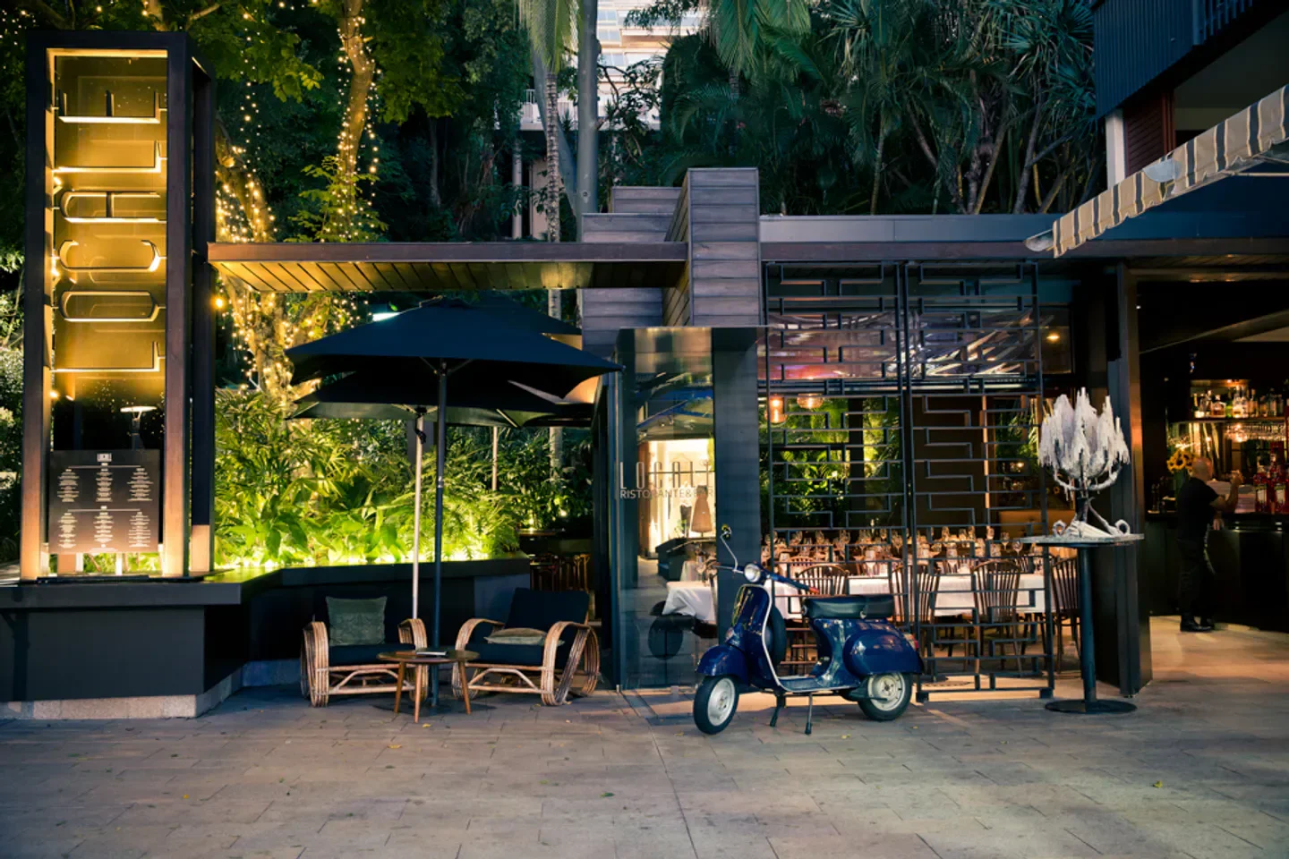 Outdoor seating and scooter at Locale Noosa, a Sunshine Coast restaurant.