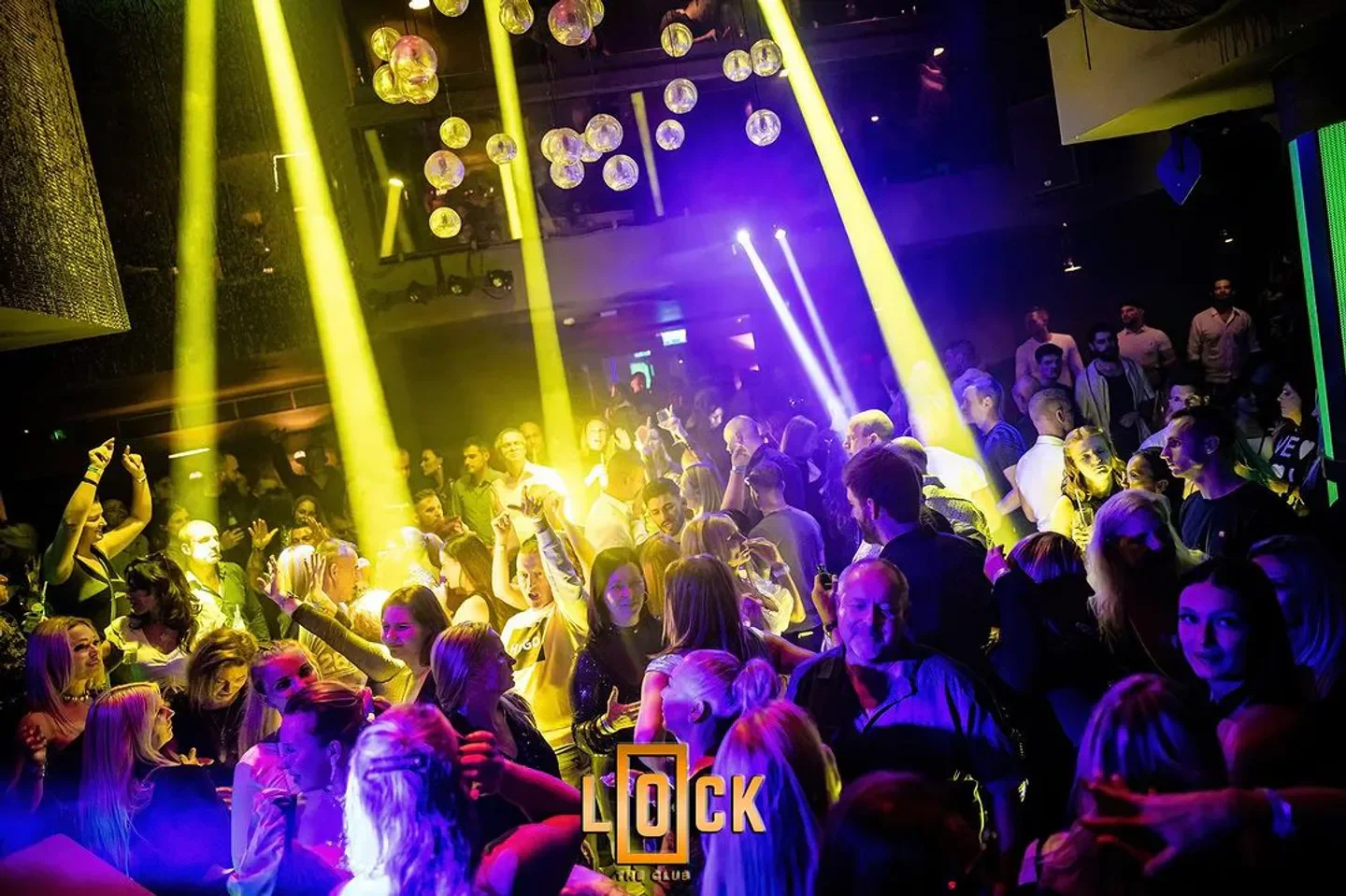 Energetic crowd enjoying the night at LOCK the club in Budapest, under vibrant lights.