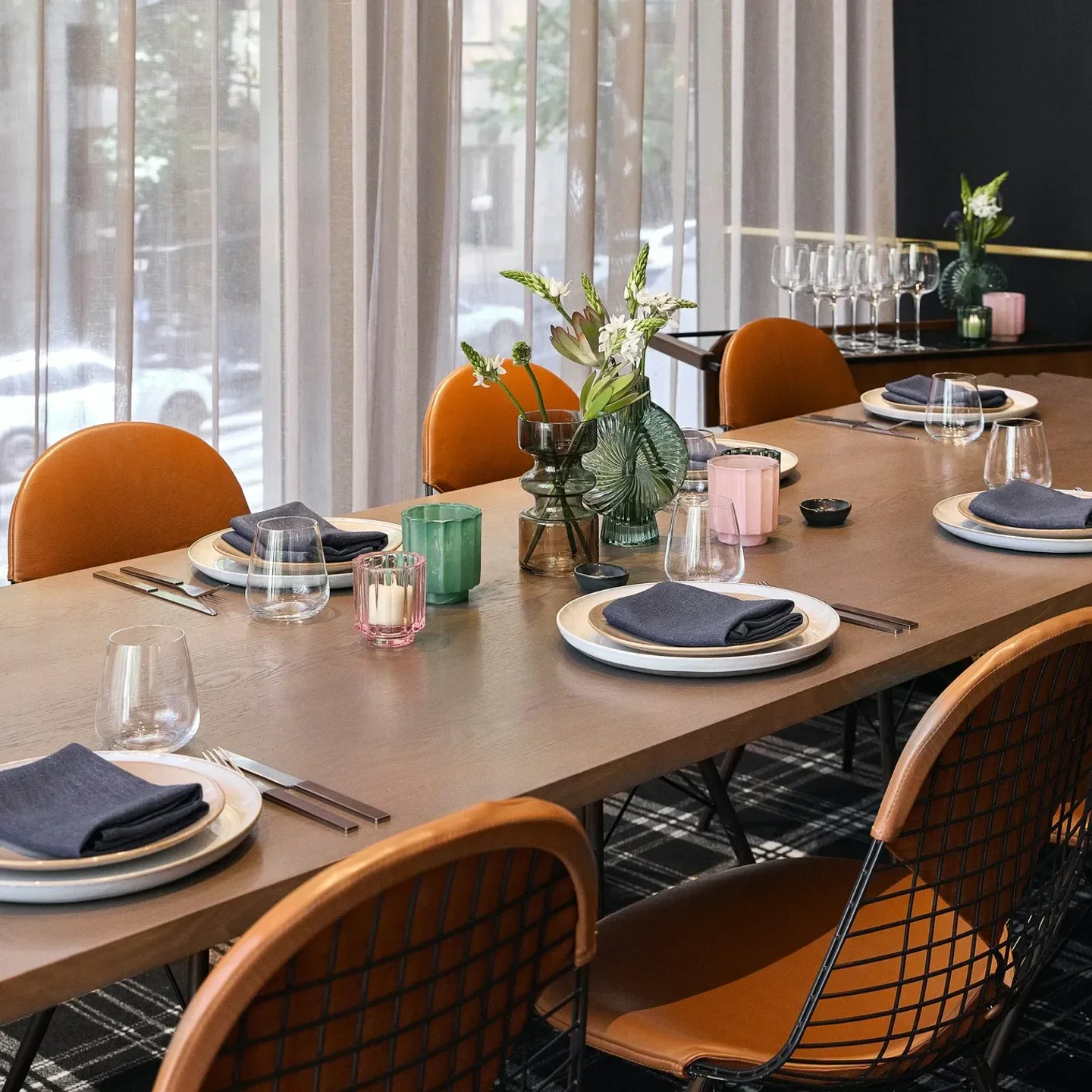 Elegant dining at Lollo in Melbourne: table setting with flowers and stylish chairs.