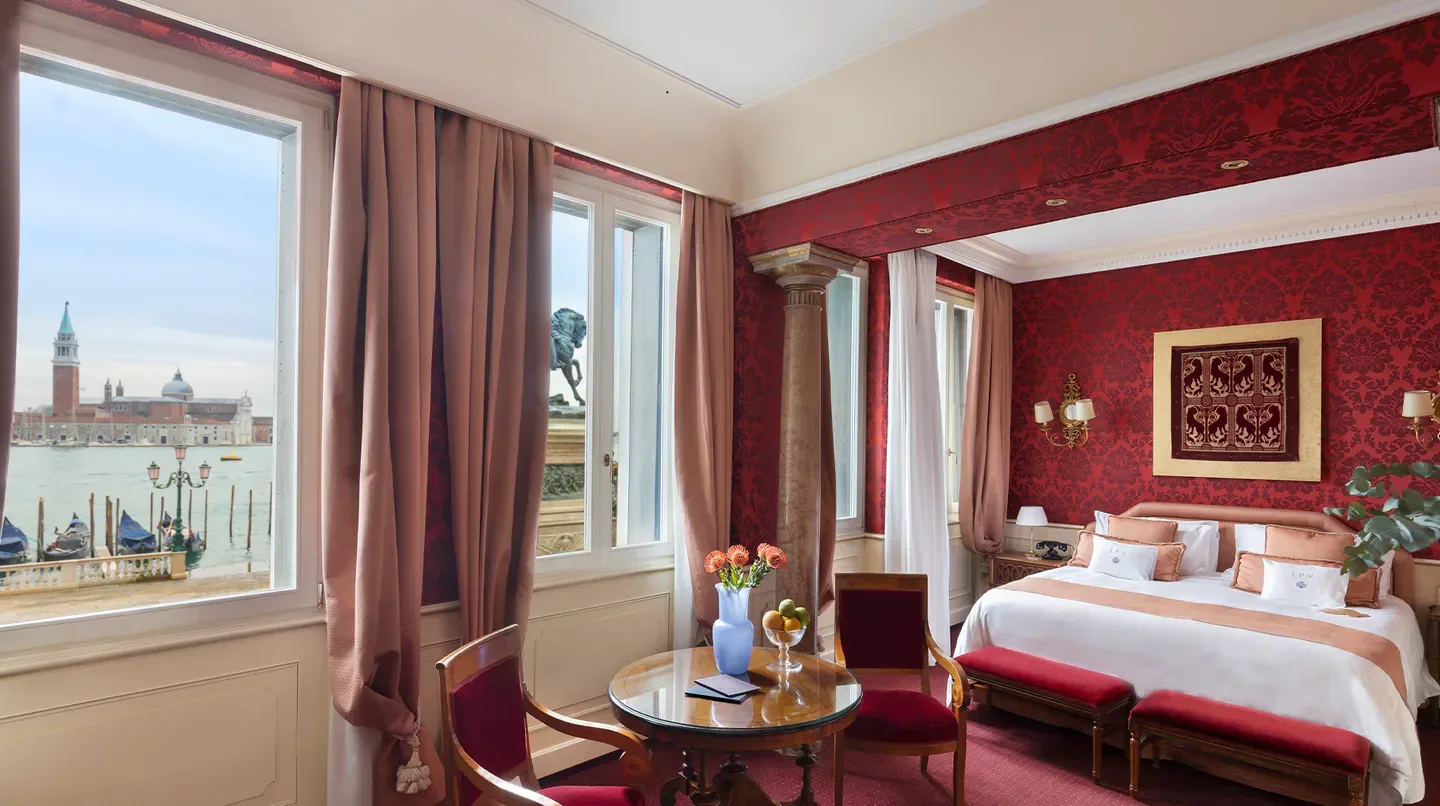 Elegant room with a view at Londra Palace Venezia, overlooking Venice's canal.