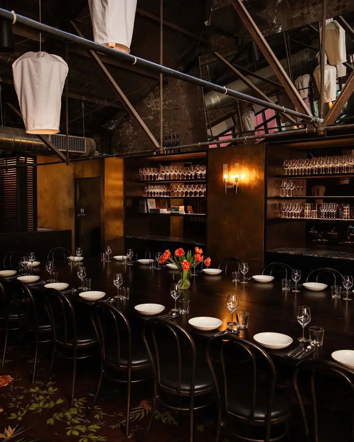 Interior of Longrain Melbourne restaurant, showcasing a long table setting with floral accents