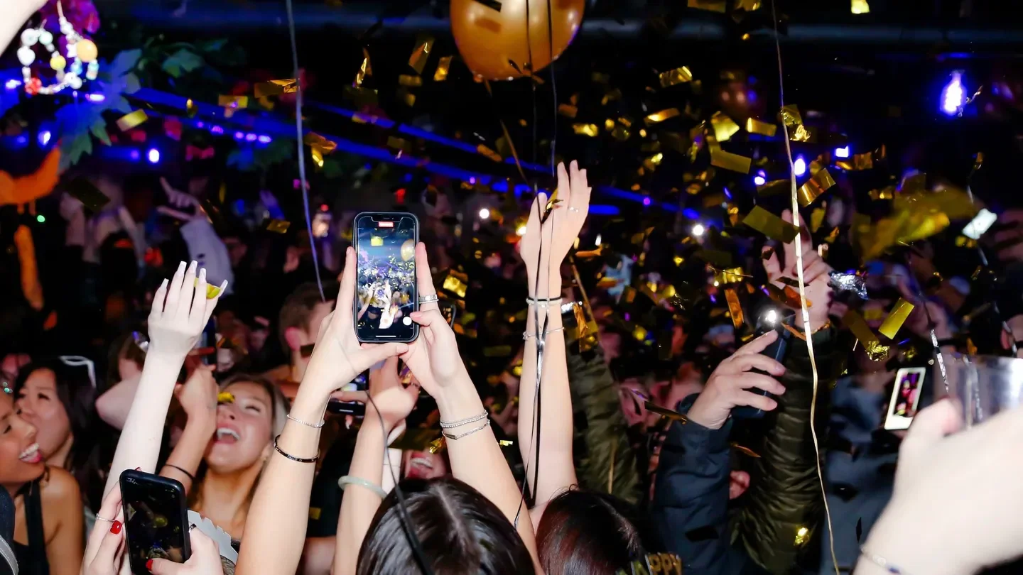 Confetti celebration at Lost and Found nightclub in Toronto with raised hands and smartphones.