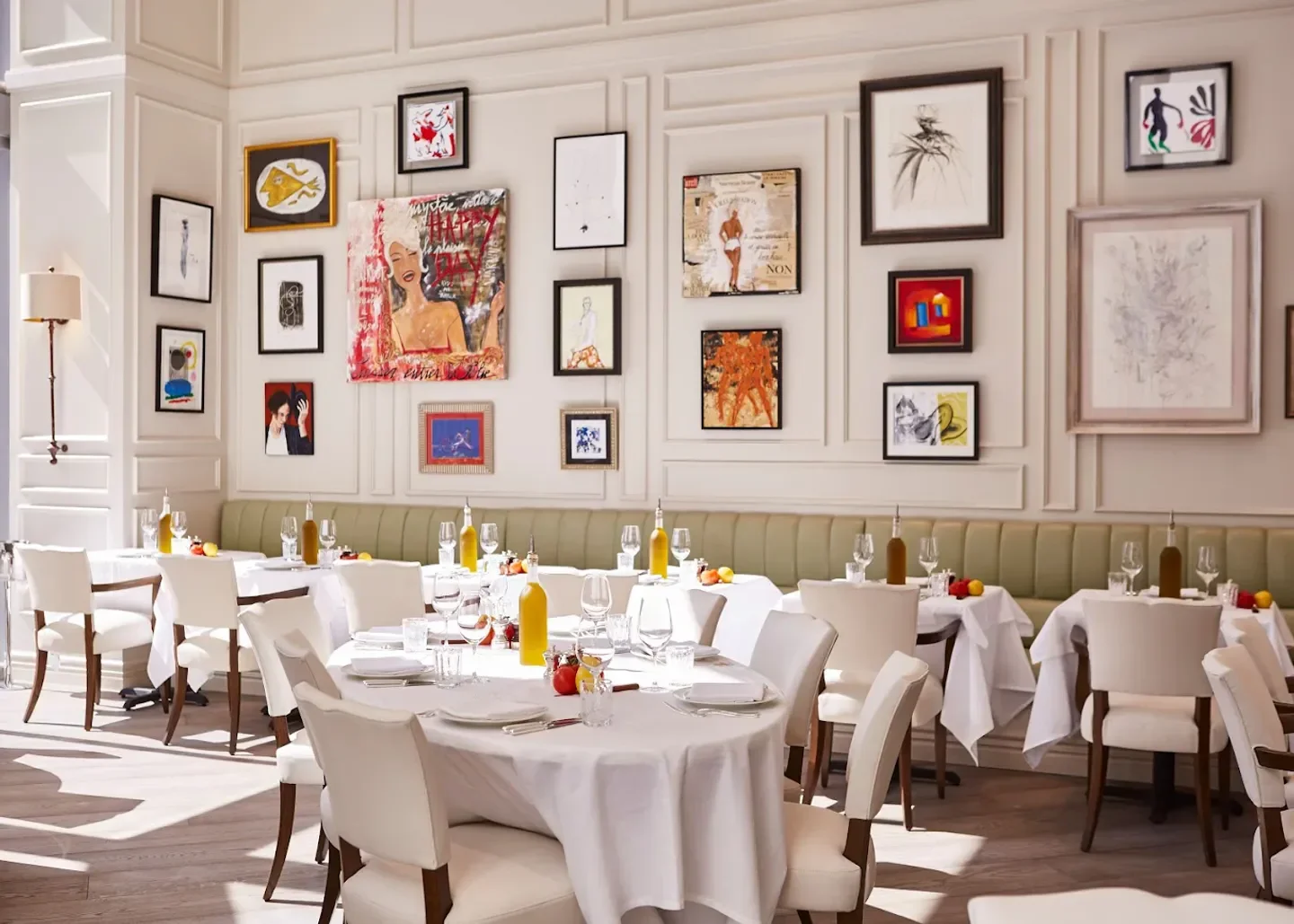 Elegant interior of LPM Miami restaurant with artwork and tables set for dining.