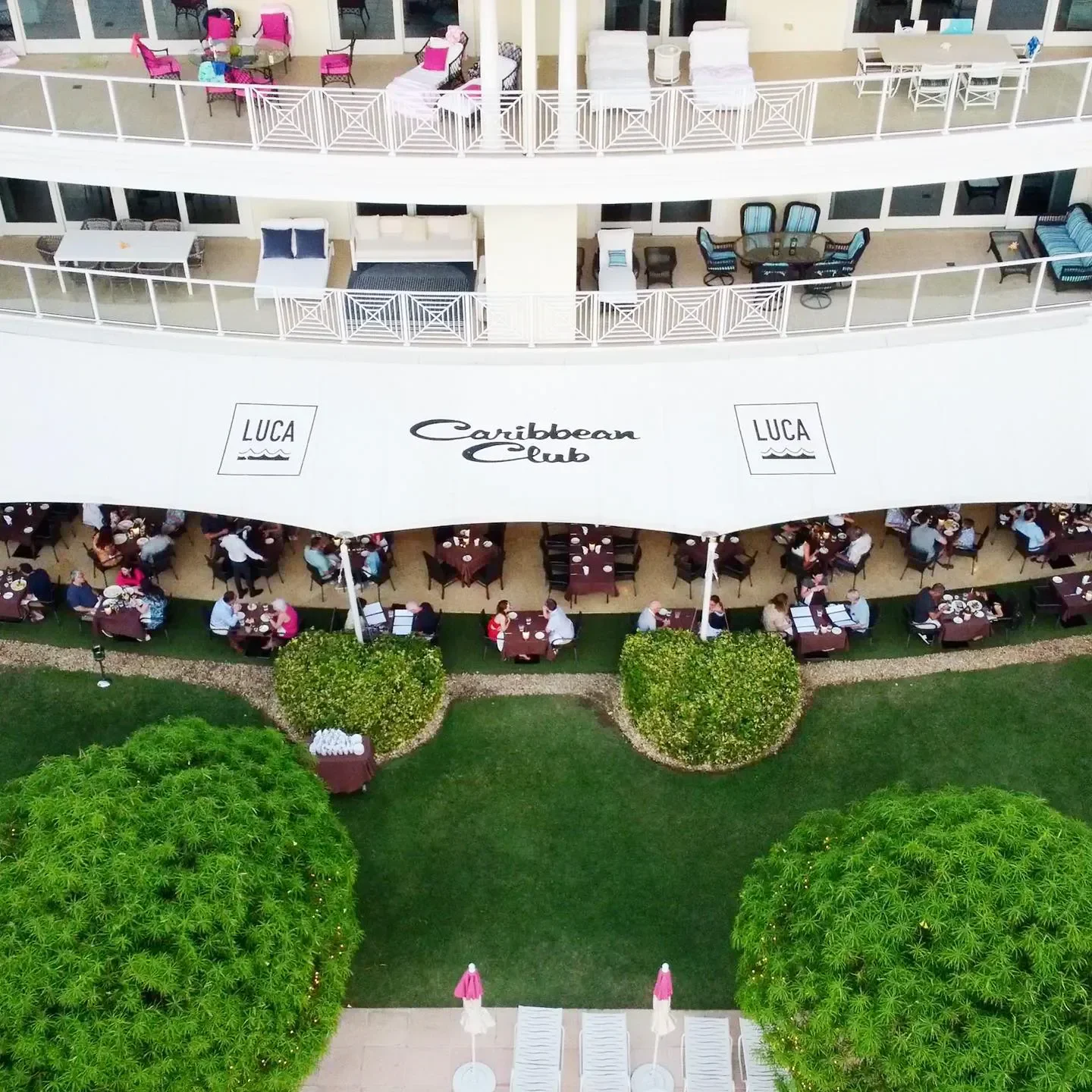 Aerial view of Luca restaurant in Grand Cayman, showcasing outdoor dining and balconies.