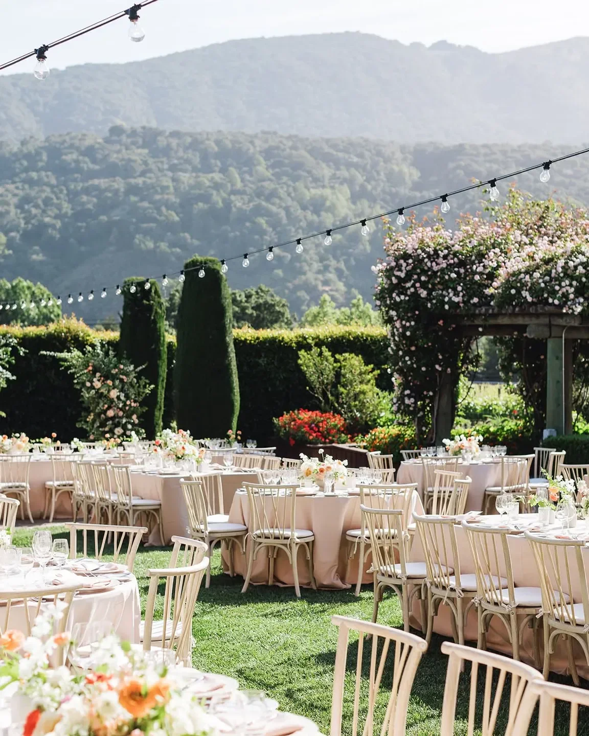 Outdoor dining area at Lucia Restaurant & Bar in Carmel with stunning garden and mountain views