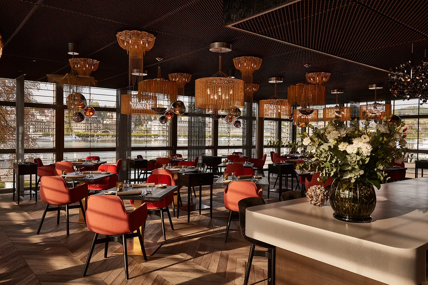 Interior of Lucide restaurant in Lucerne, featuring stylish decor and riverside views.