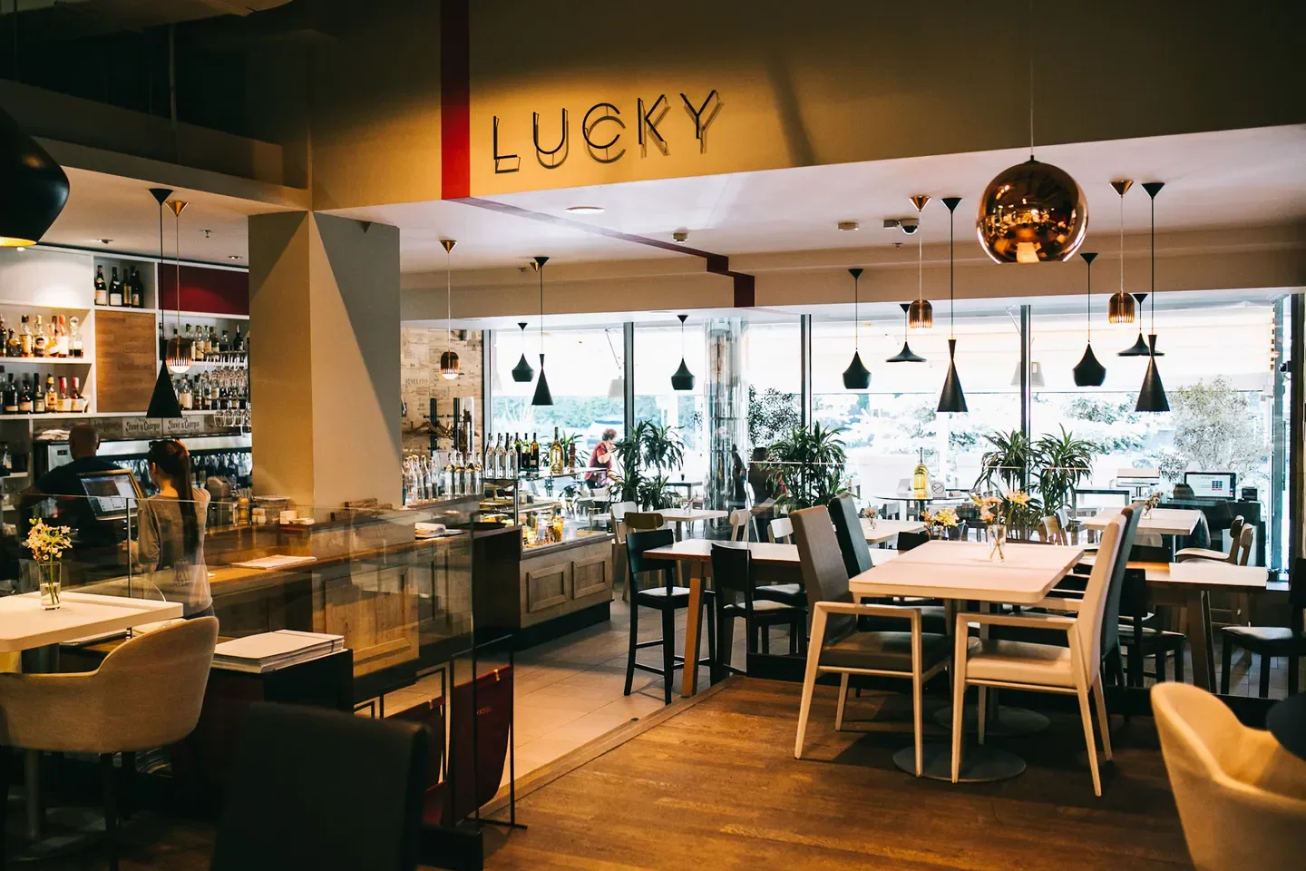 Interior of Lucky Restaurant Vinotheque in Kyiv, with stylish decor and seating area.
