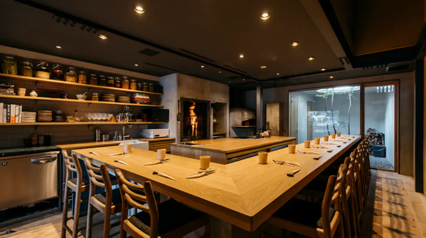 Interior view of LURRA° restaurant in Kyoto, featuring open kitchen and dining area.