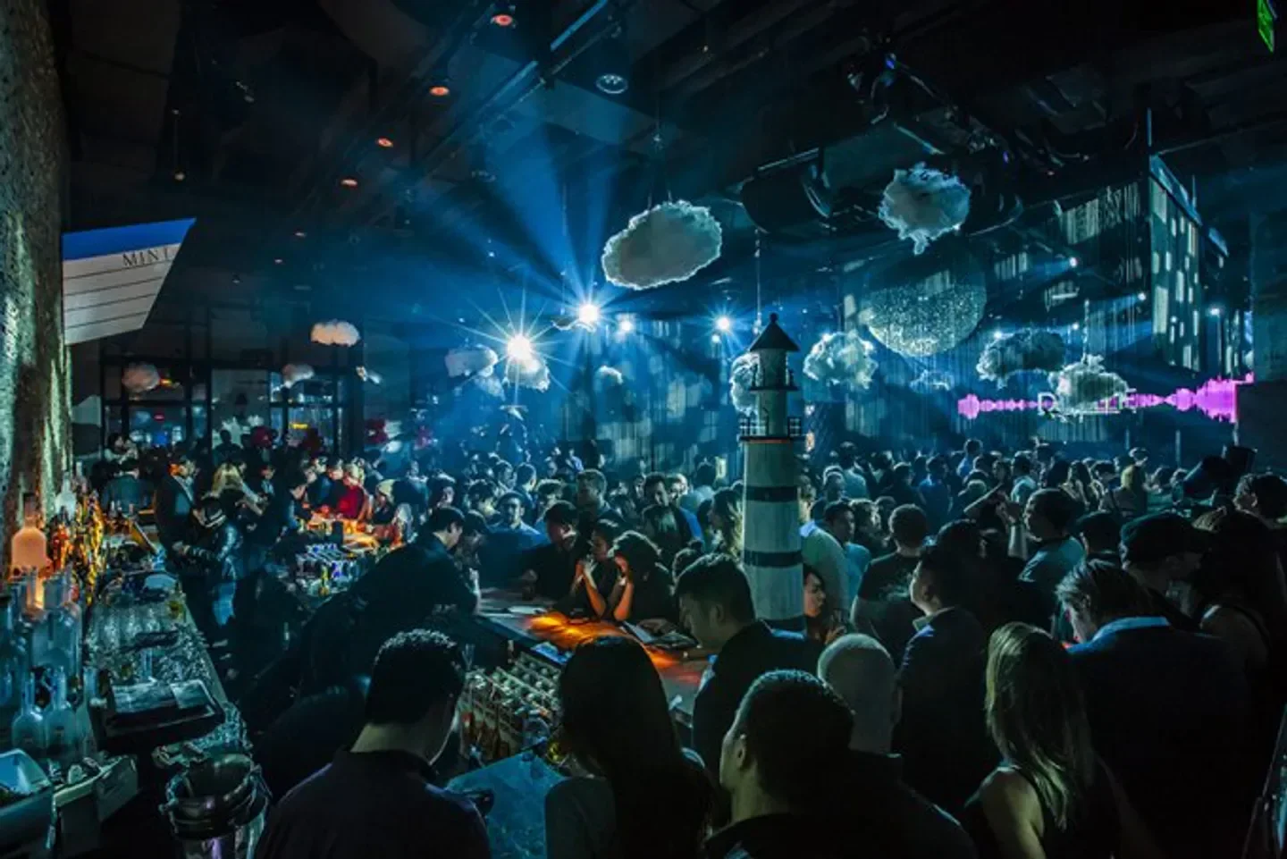 Busy night at M1NT Shanghai, a stylish nightclub with cloud decorations and a lighthouse.