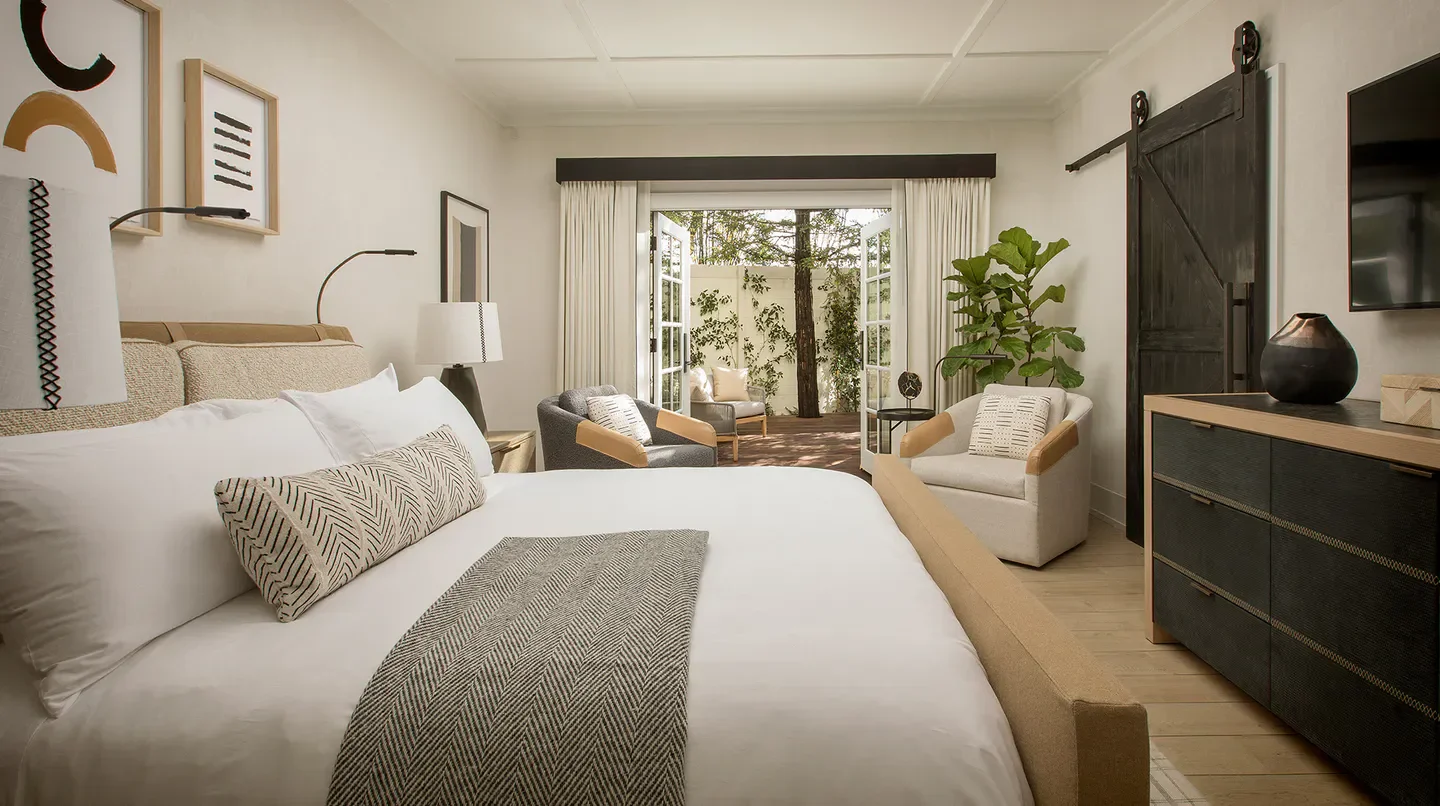 Cozy bedroom at MacArthur Place Hotel & Spa in Sonoma, with outdoor seating.