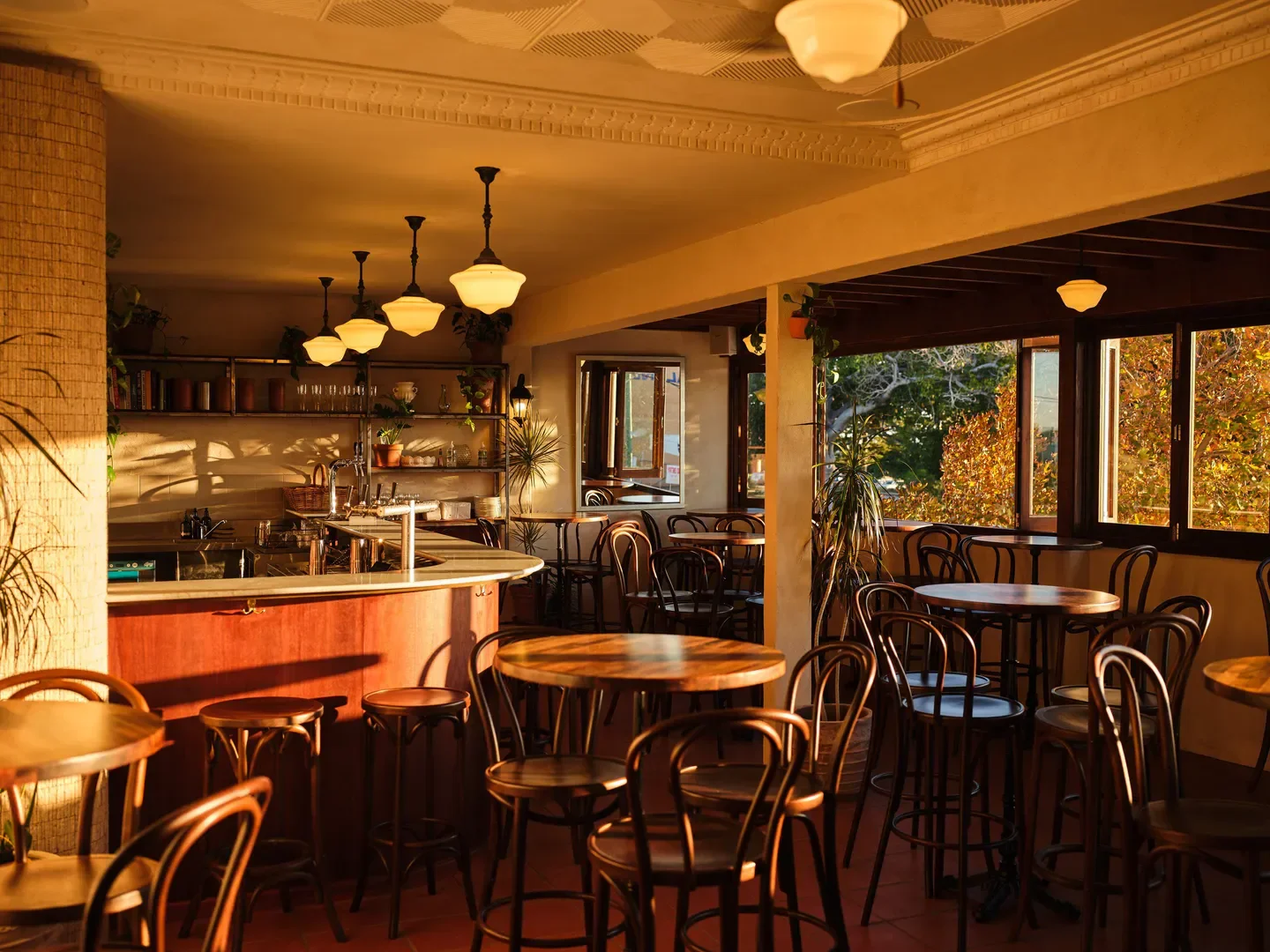 Interior of Madalena's restaurant in Perth, featuring wooden tables and warm lighting.