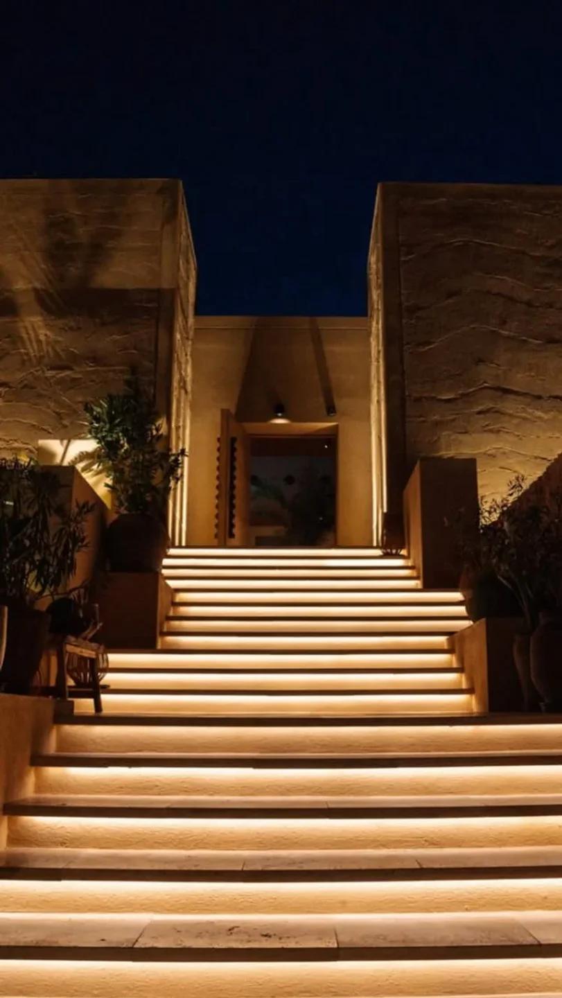 Madunia Ibiza restaurant exterior featuring a dramatic entrance with illuminated stairs and warm lighting at night