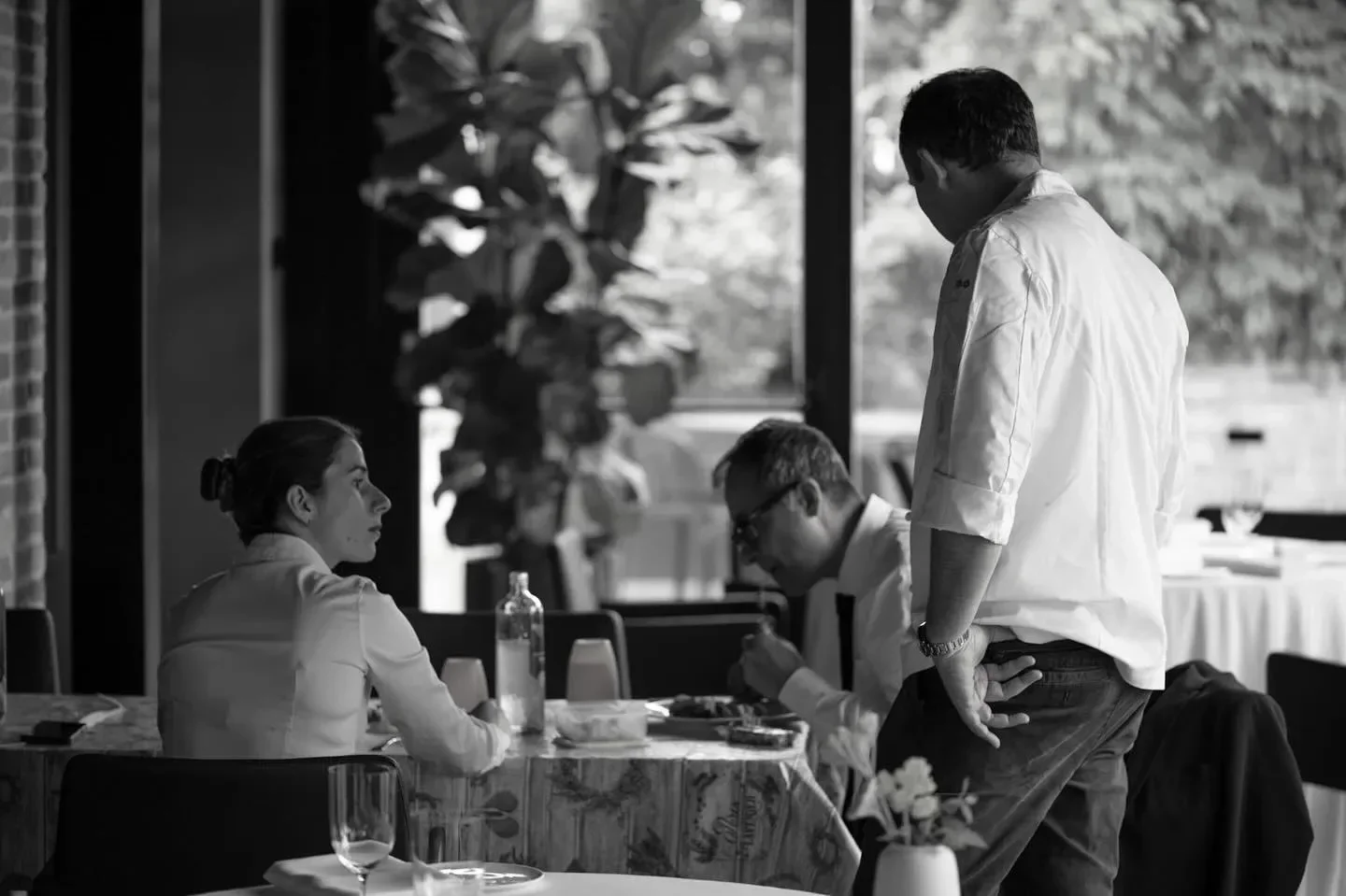 Dining scene at Magnolia restaurant in Emilia-Romagna, Italy with staff and patrons.