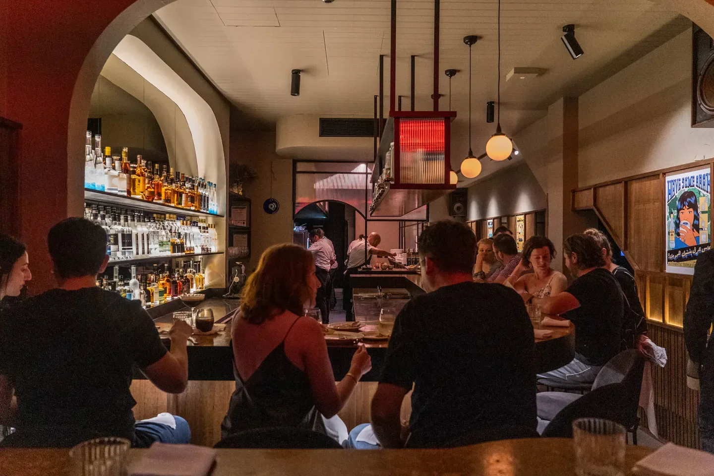 Interior view of Maha North in Melbourne, with patrons at the bar and restaurant staff.