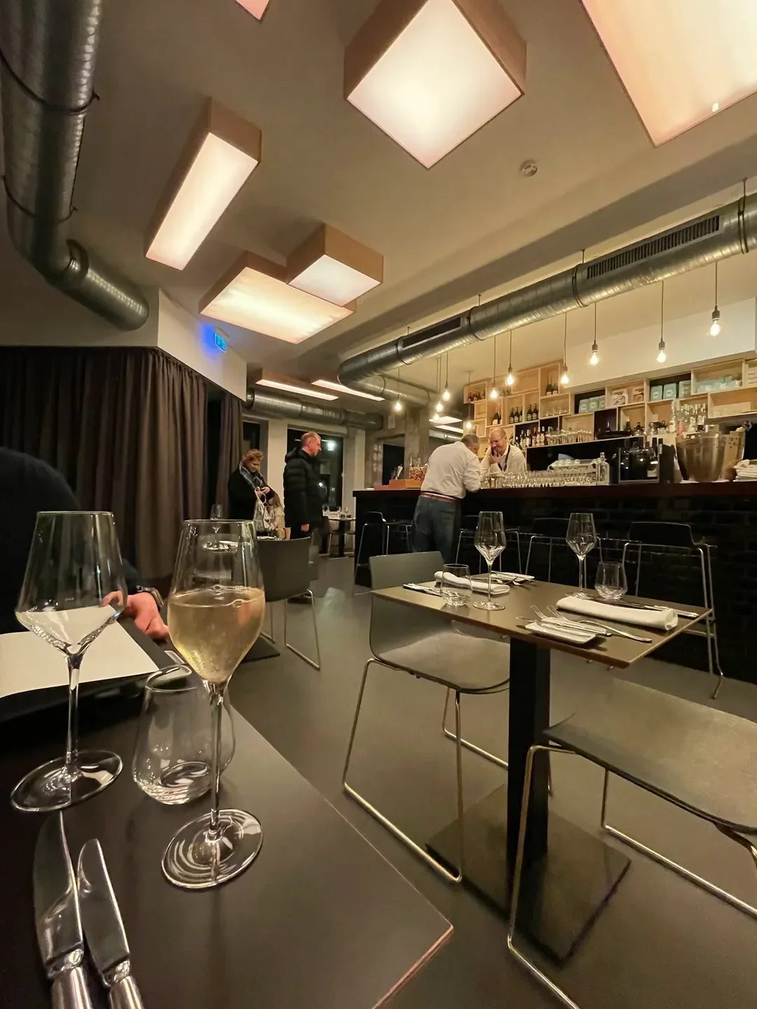 Interior of maiBeck restaurant in Cologne with wine glasses and elegant decor