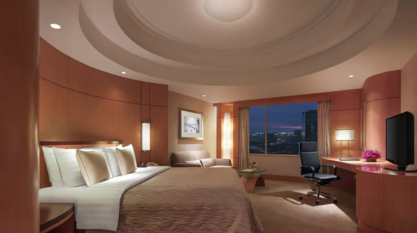 Elegant hotel room at Makati Shangri-La, Manila, with city view in Manila at night.