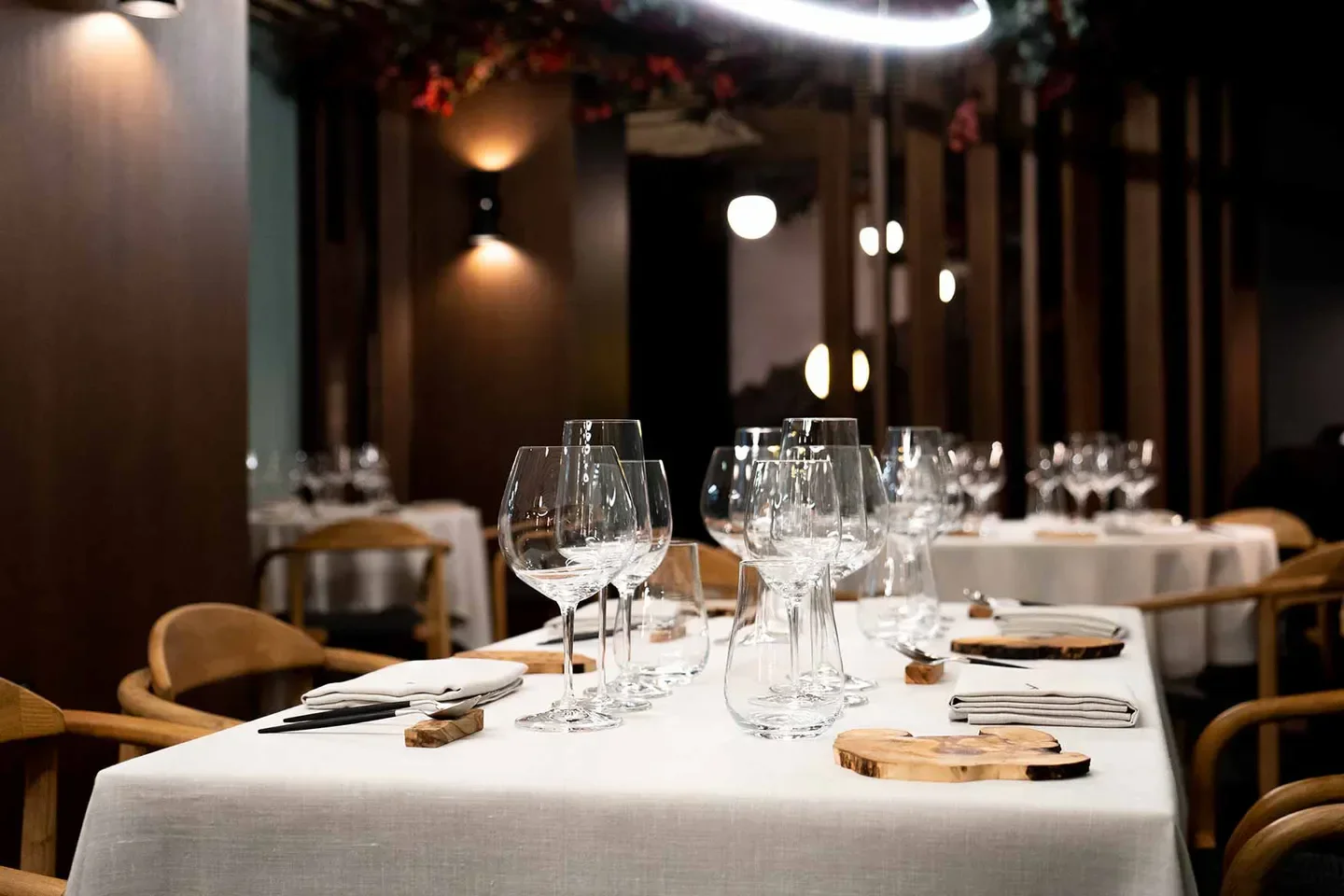 Elegant dining at Malak restaurant in Andalusia, with wine glasses and cozy atmosphere